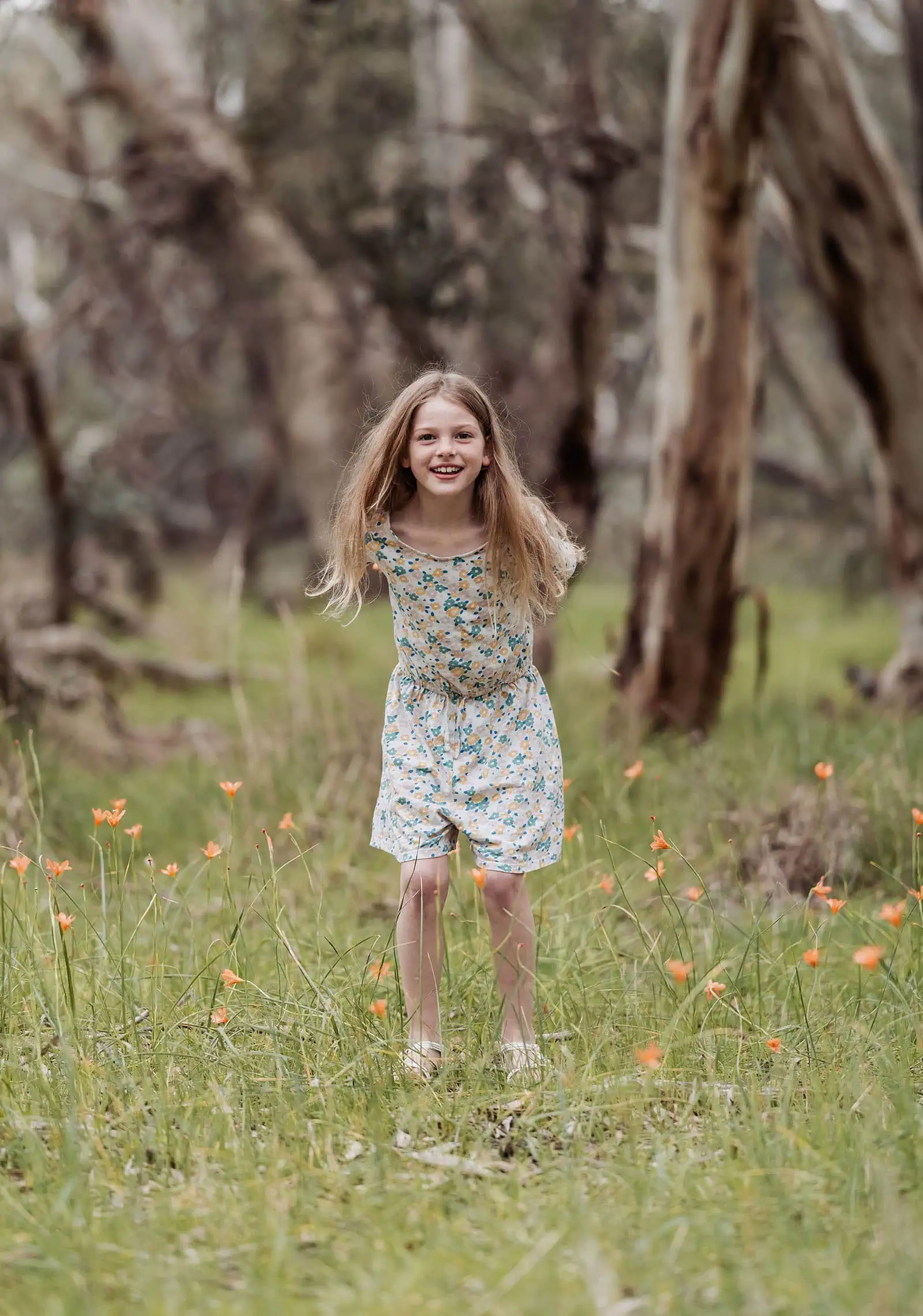 myponga family photography 3 Girl running through a blossoming flower meadow in springtime.