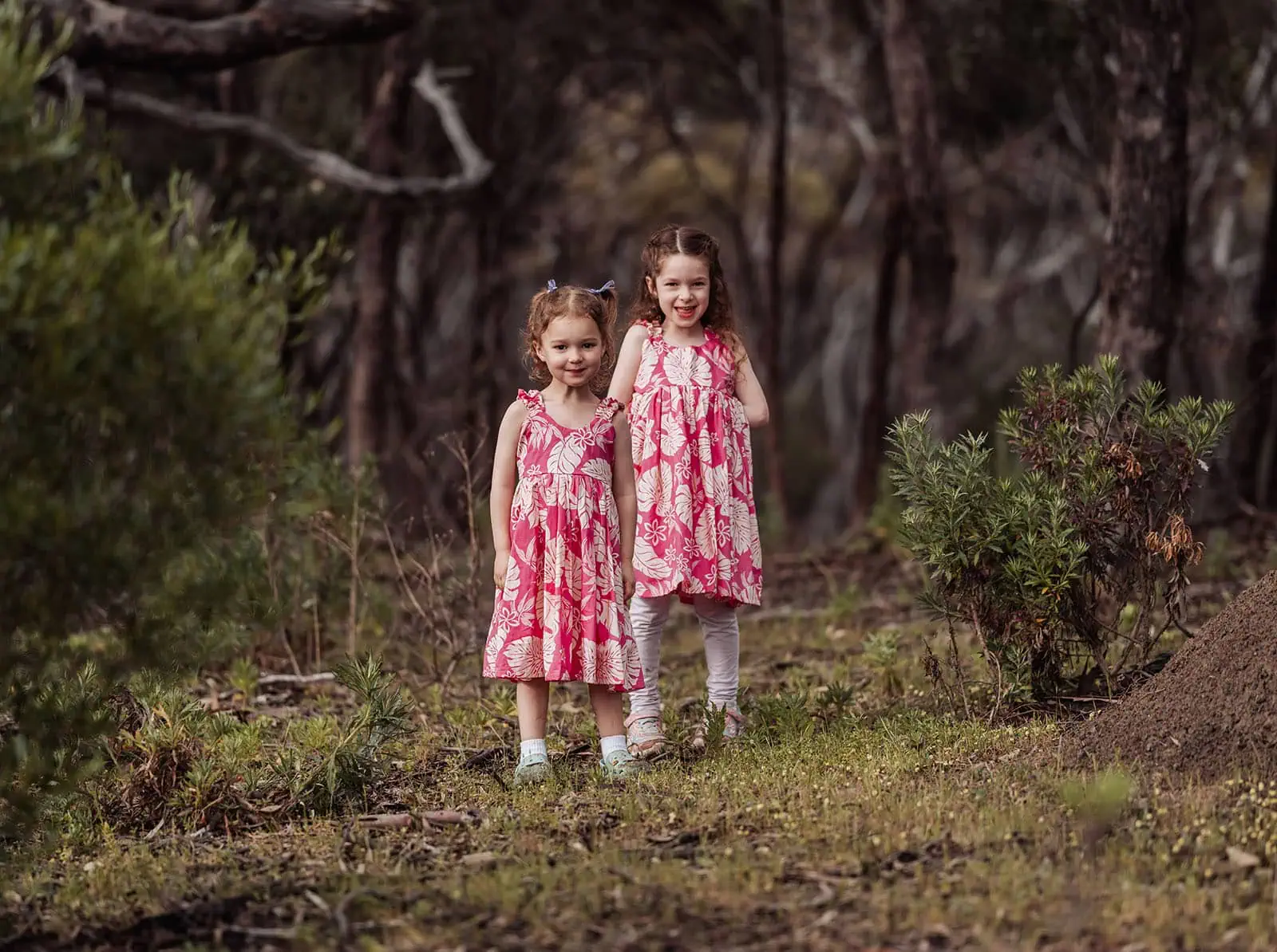 happy valley reservoir family photoshoot 16 Girls in pink dresses in a woodland setting.