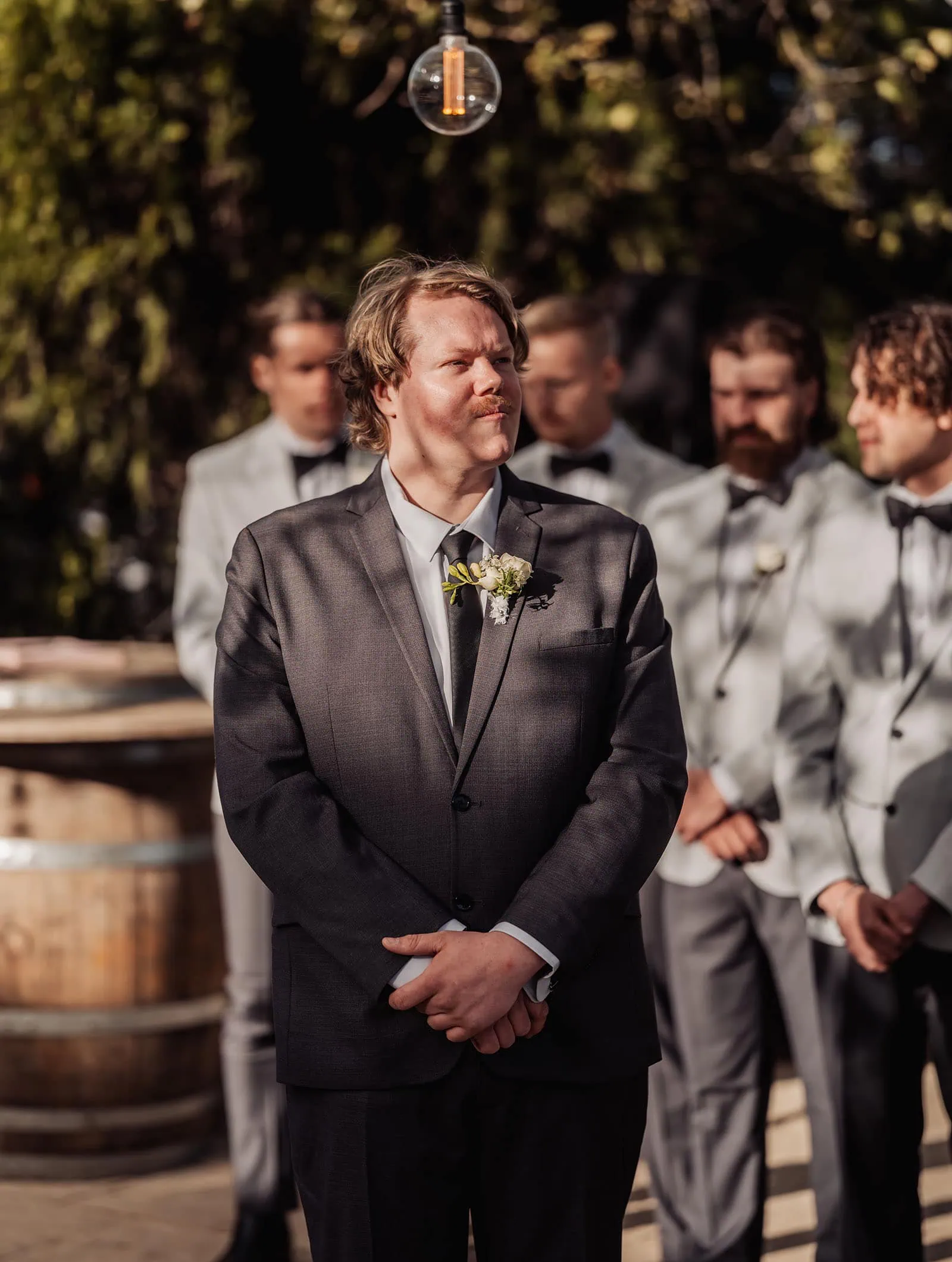 beach rd wines wedding - hana & jessie 54 Groom in formal attire at outdoor wedding event.