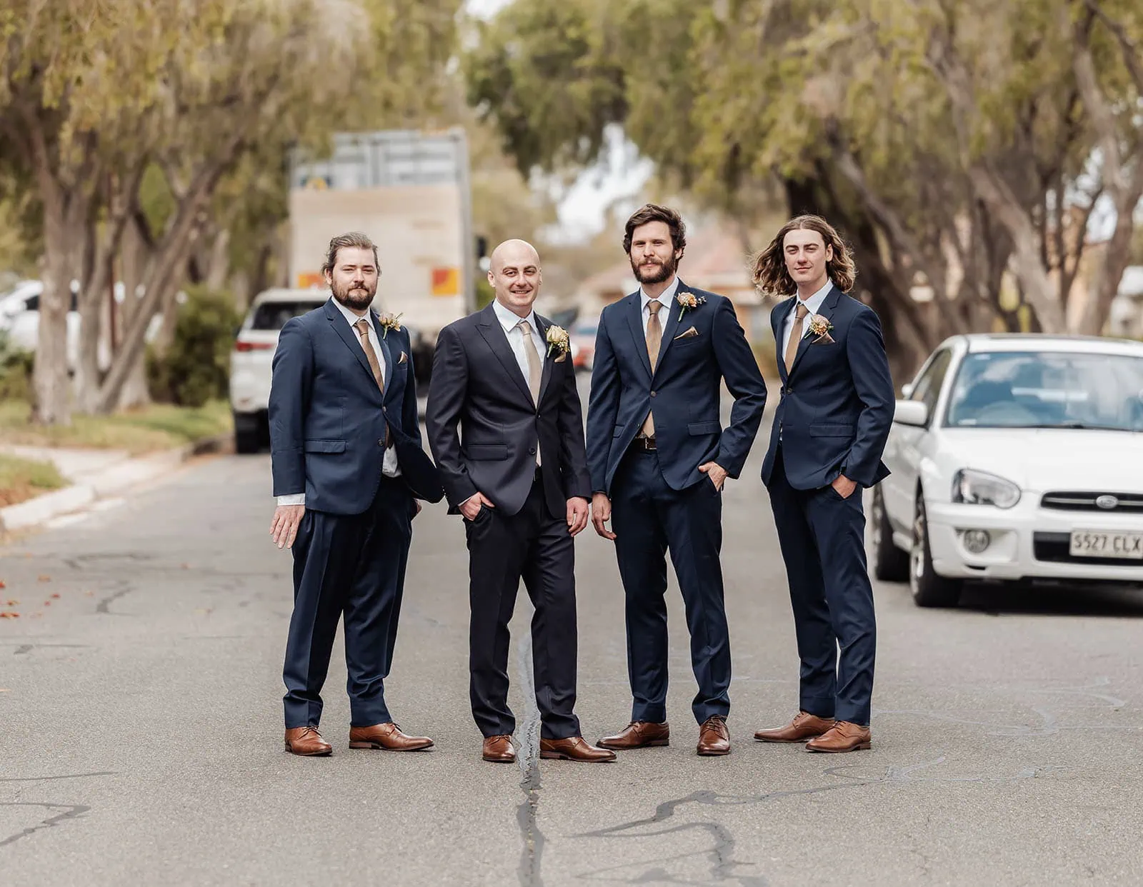 grand cru estate wedding - isabella & nick 103 Groomsmen in stylish blue suits pose elegantly for a wedding photo.