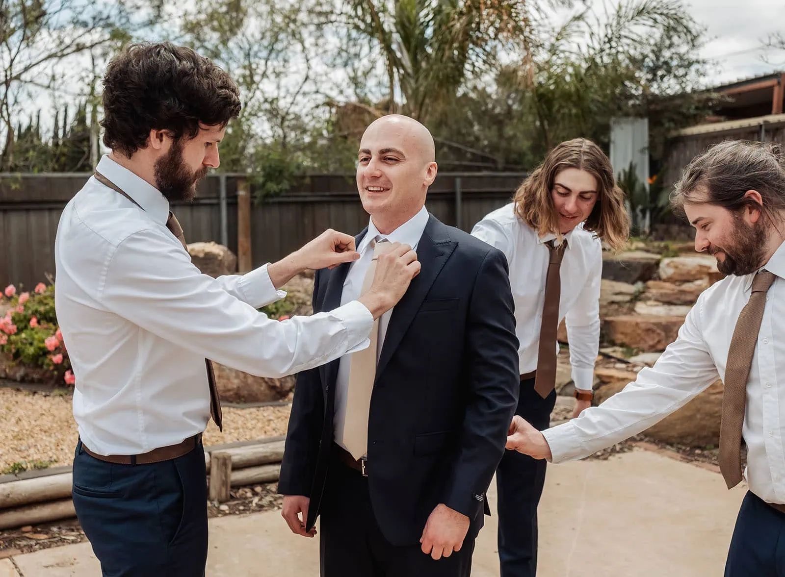 grand cru estate wedding - isabella & nick 99 Groomsmen getting ready for wedding in suits, laughter, and camaraderie.