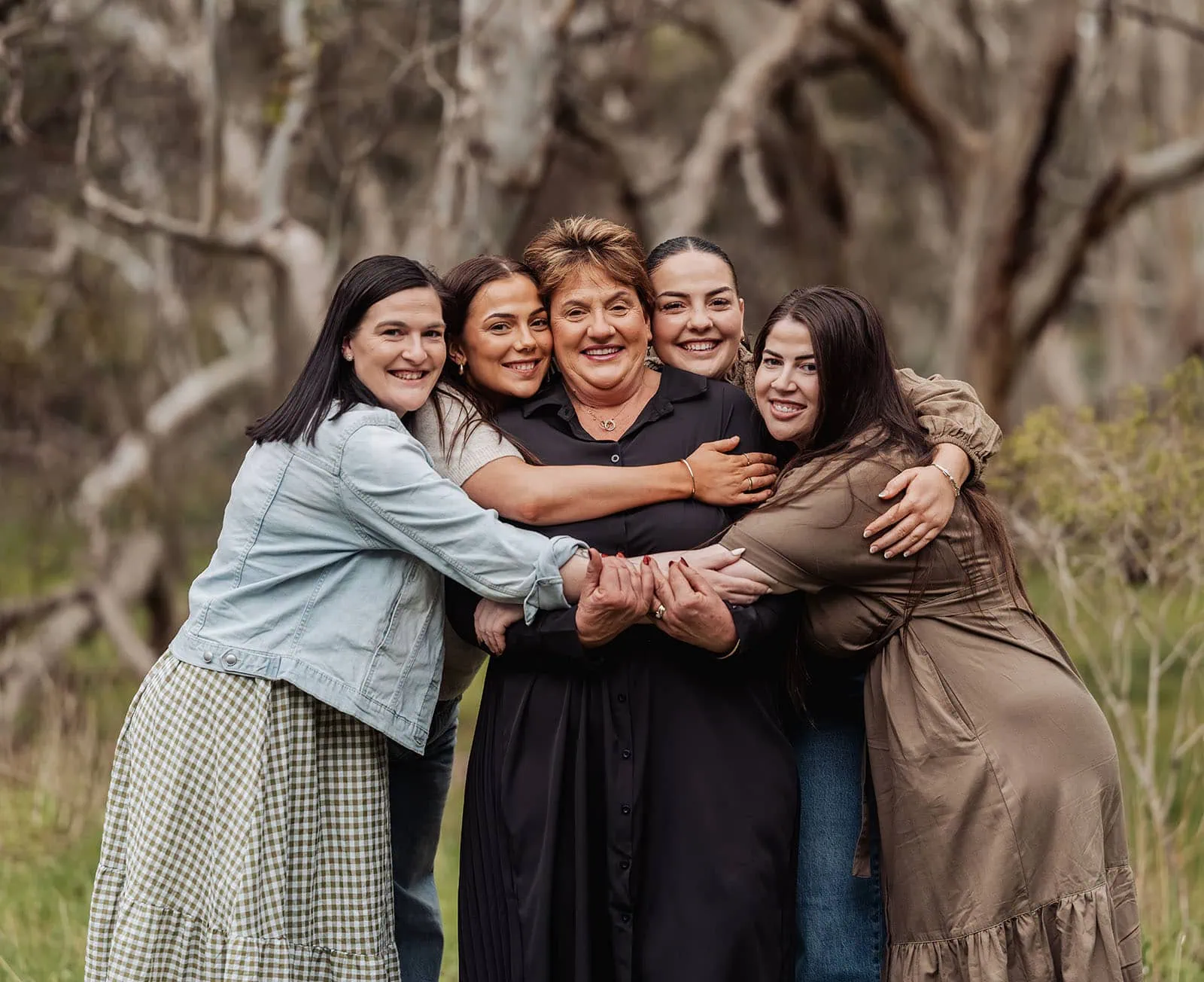 myponga family photography 18 Friends hugging outside, smiling under the sun.