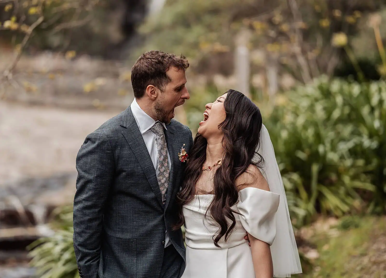 utopia waterfall gully wedding - sally & ben 235 Smiling bride and groom share a joyful moment on their wedding day.