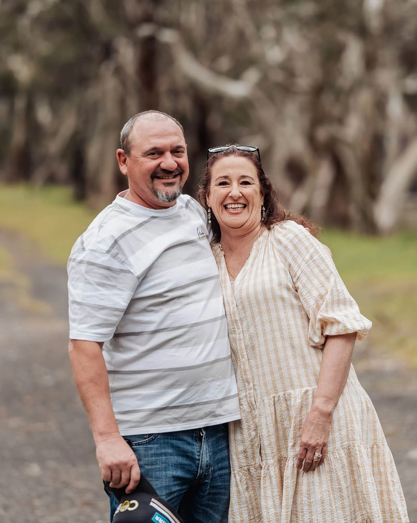 myponga family photography 7 Smiling couple enjoying a sunny day outside, embracing nature and happiness.