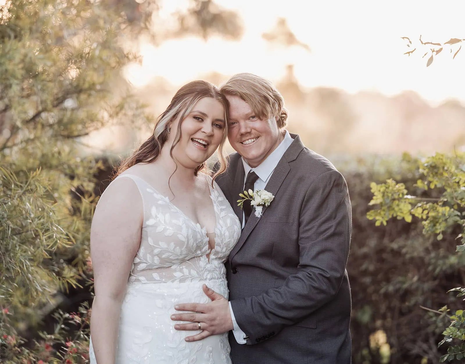 beach rd wines wedding - hana & jessie 75 Smiling couple in wedding attire embracing outdoors.