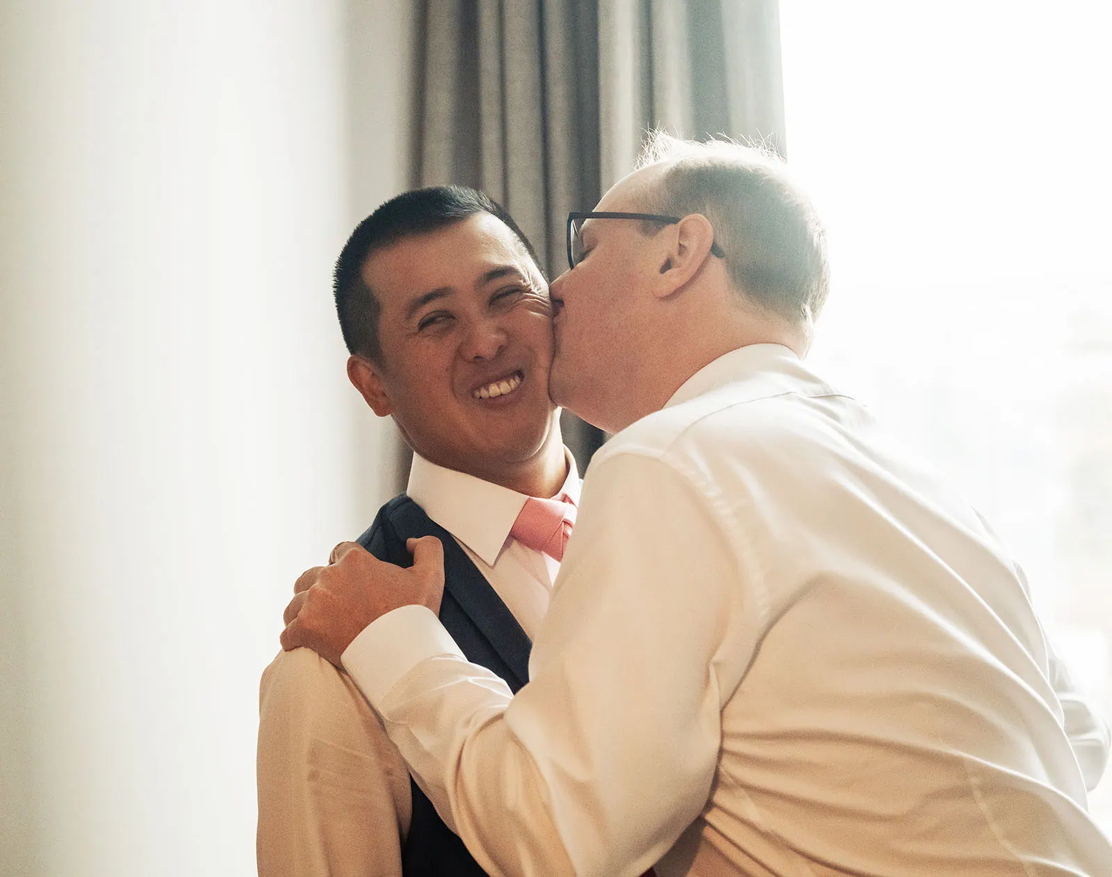 adelaide botanic gardens summerhouse wedding - belinda & ian 127 Friends sharing a warm embrace, conveying love and connection.
