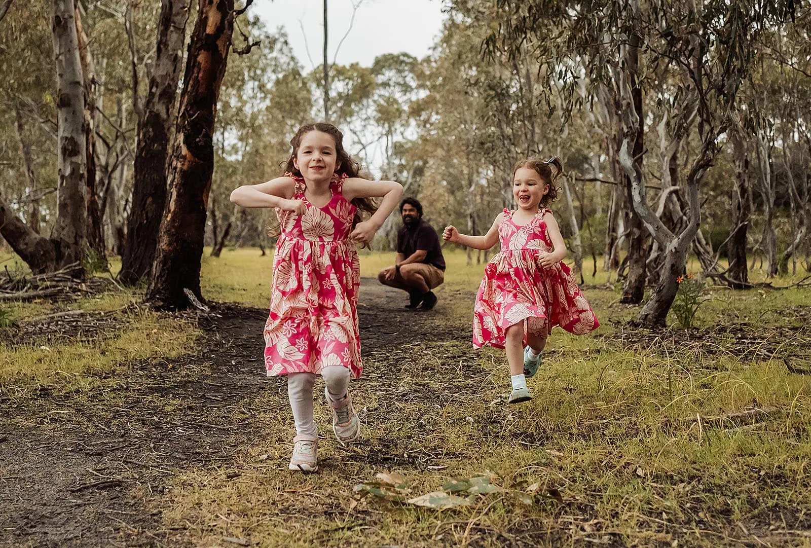 happy valley reservoir family photoshoot 4 Children playing happily on a forest path.