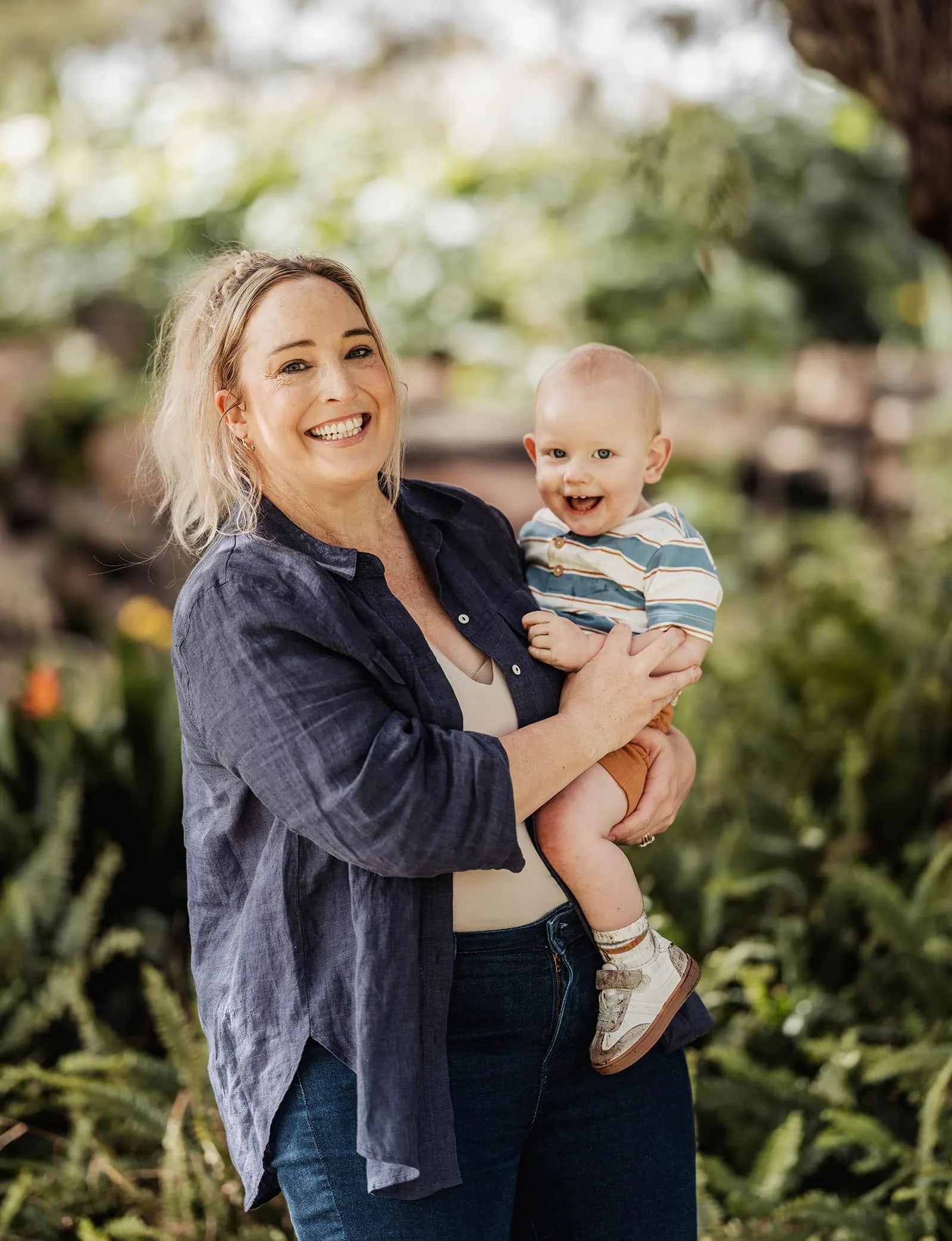 southern parklands family photography 42 Joyful family enjoying vibrant garden blooms on a sunny day.