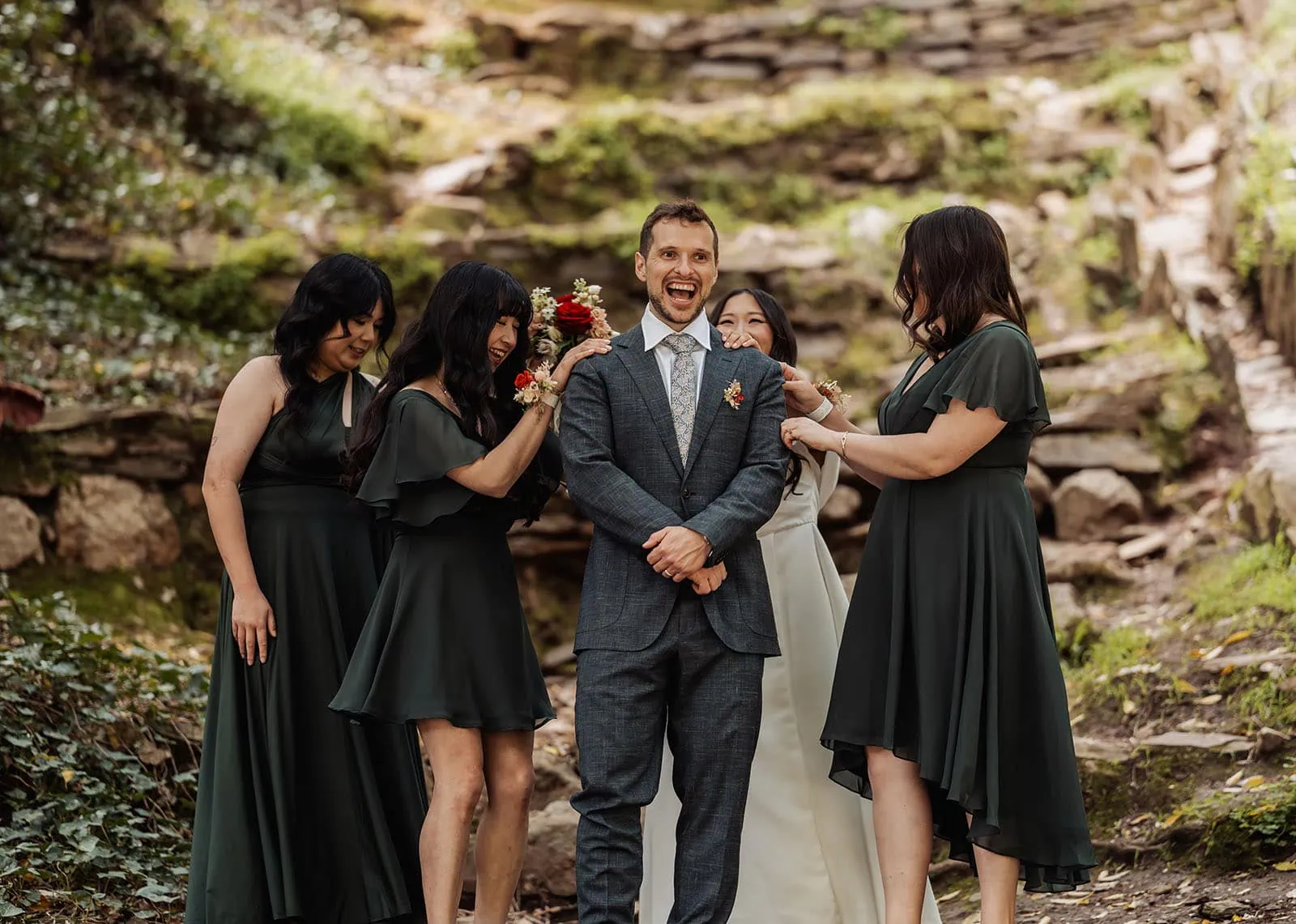 utopia waterfall gully wedding - sally & ben 246 Joyful wedding group celebrates outdoors with smiles and laughter.