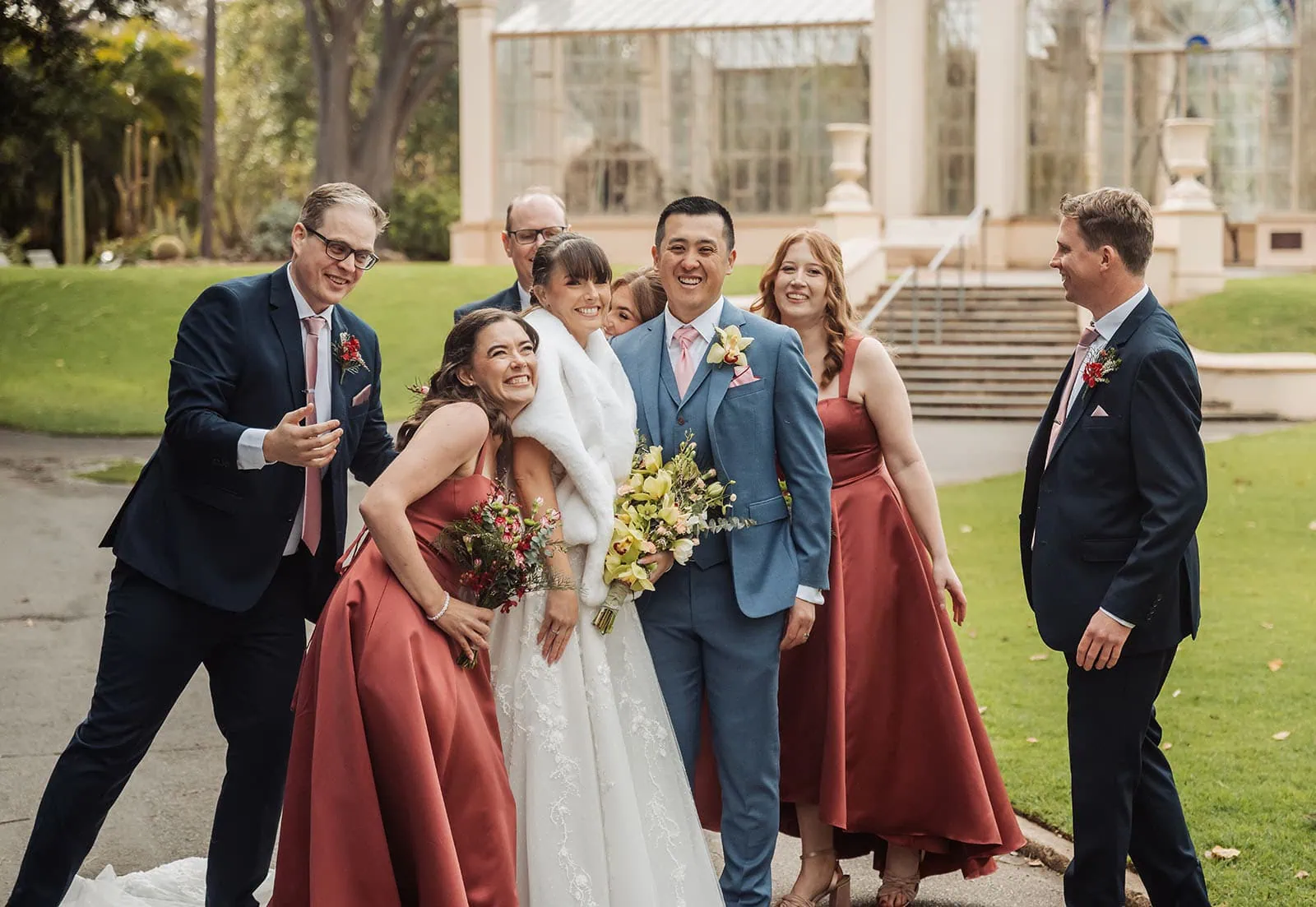 adelaide botanic gardens summerhouse wedding - belinda & ian 178 Happy guests celebrate at vibrant outdoor wedding party.