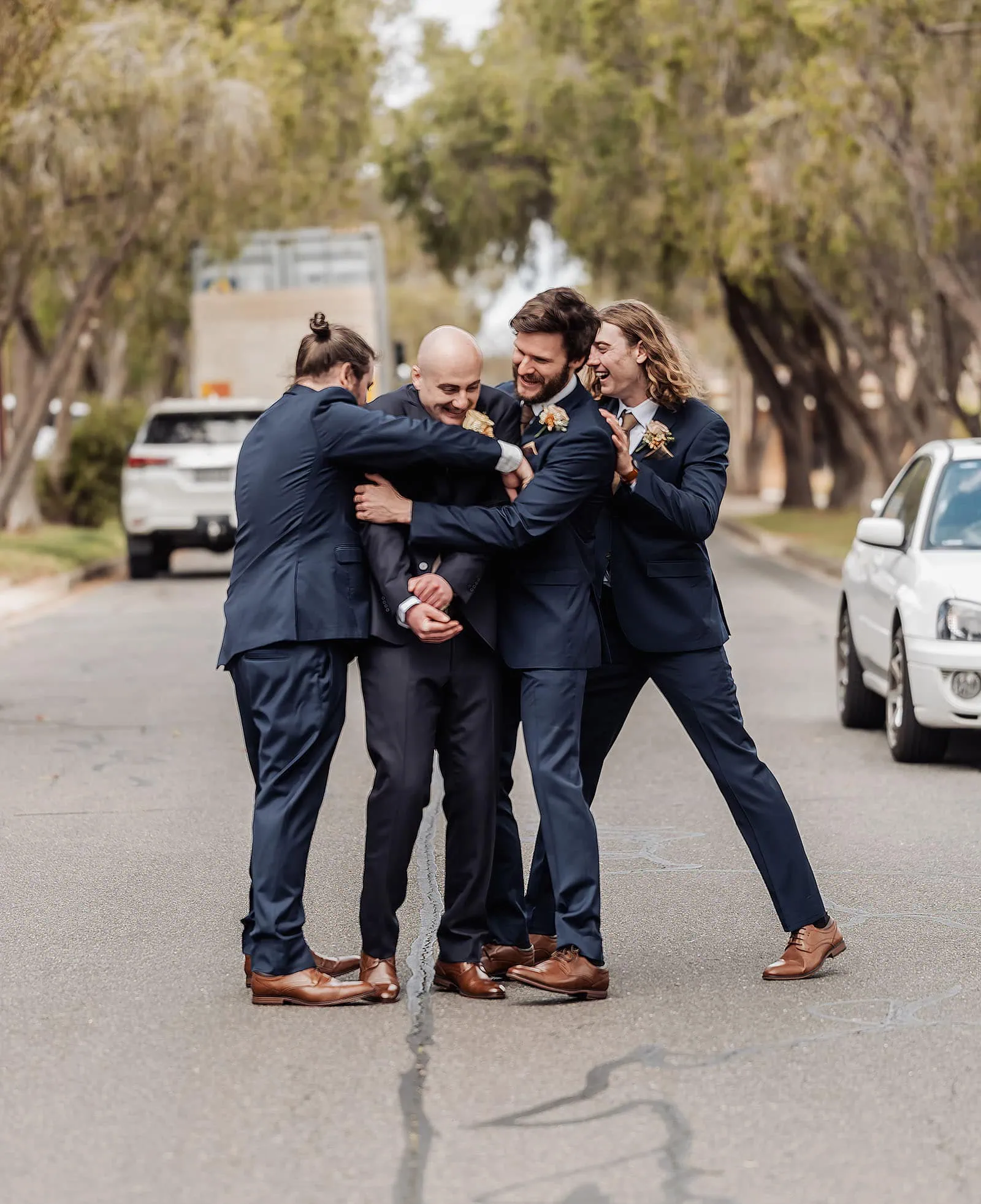 grand cru estate wedding - isabella & nick 104 Joyful wedding moment with friends hugging, celebrating love and unity.