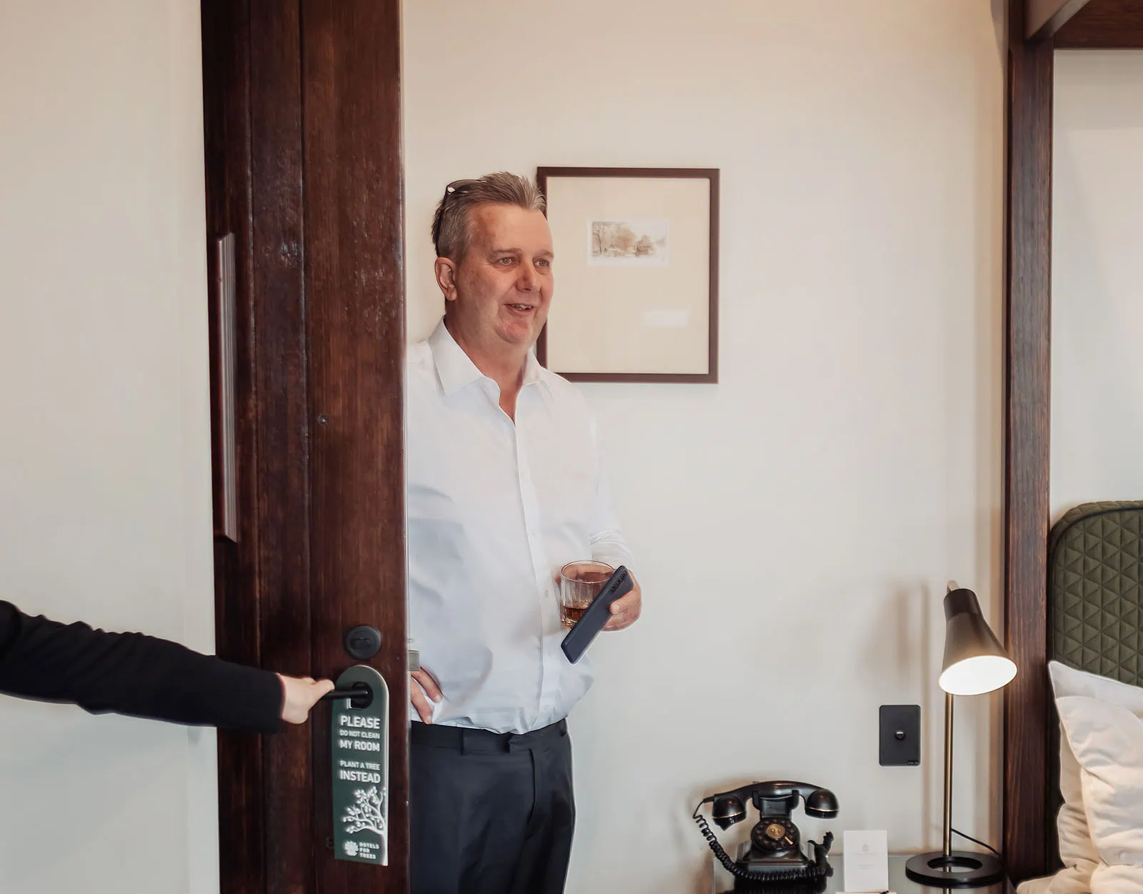 mt lofty house elopement - kimberley & michael 173 Man standing in modern doorway, stylish room interior.