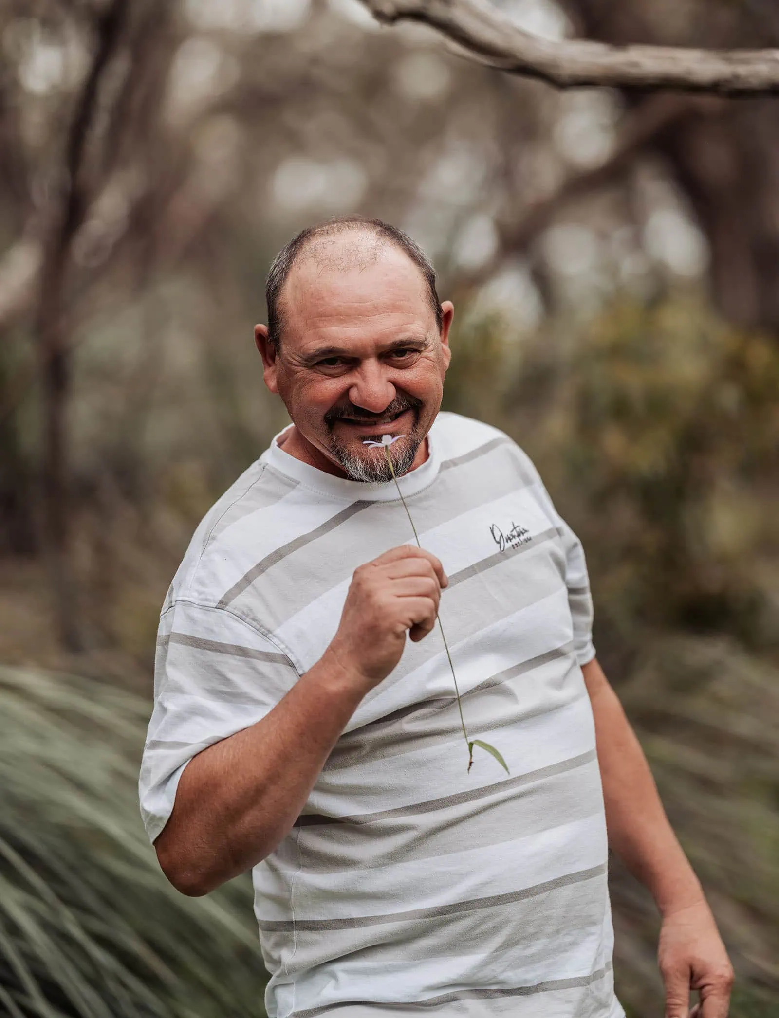 myponga family photography 31 Smiling man enjoying nature outdoors, surrounded by greenery.