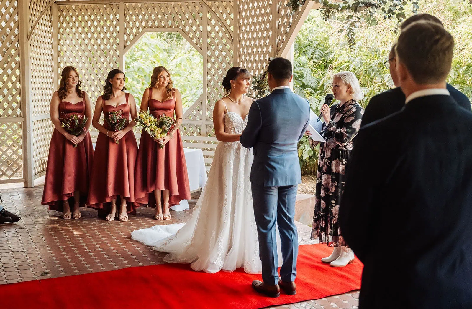 adelaide botanic gardens summerhouse wedding - belinda & ian 163 Elegant outdoor wedding under a floral-decorated gazebo.