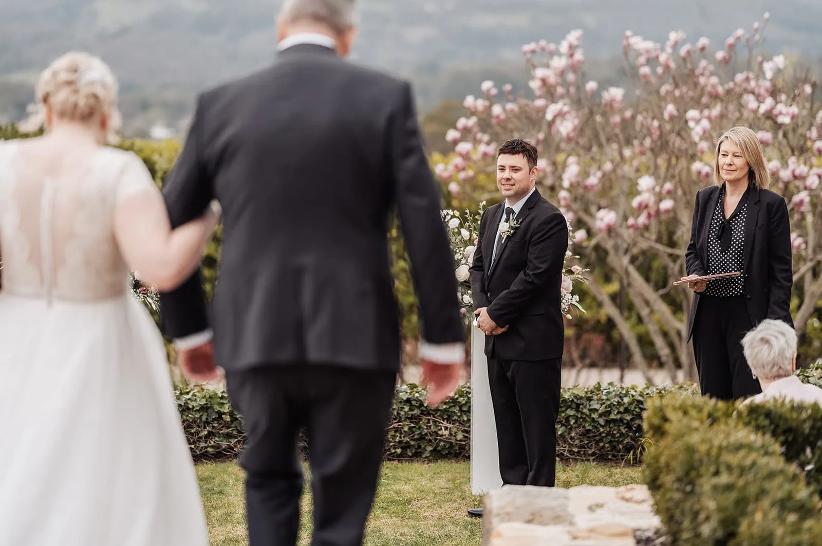 mt lofty house elopement - kimberley & michael 179 Elegant outdoor wedding ceremony with floral decorations and guests in attendance.