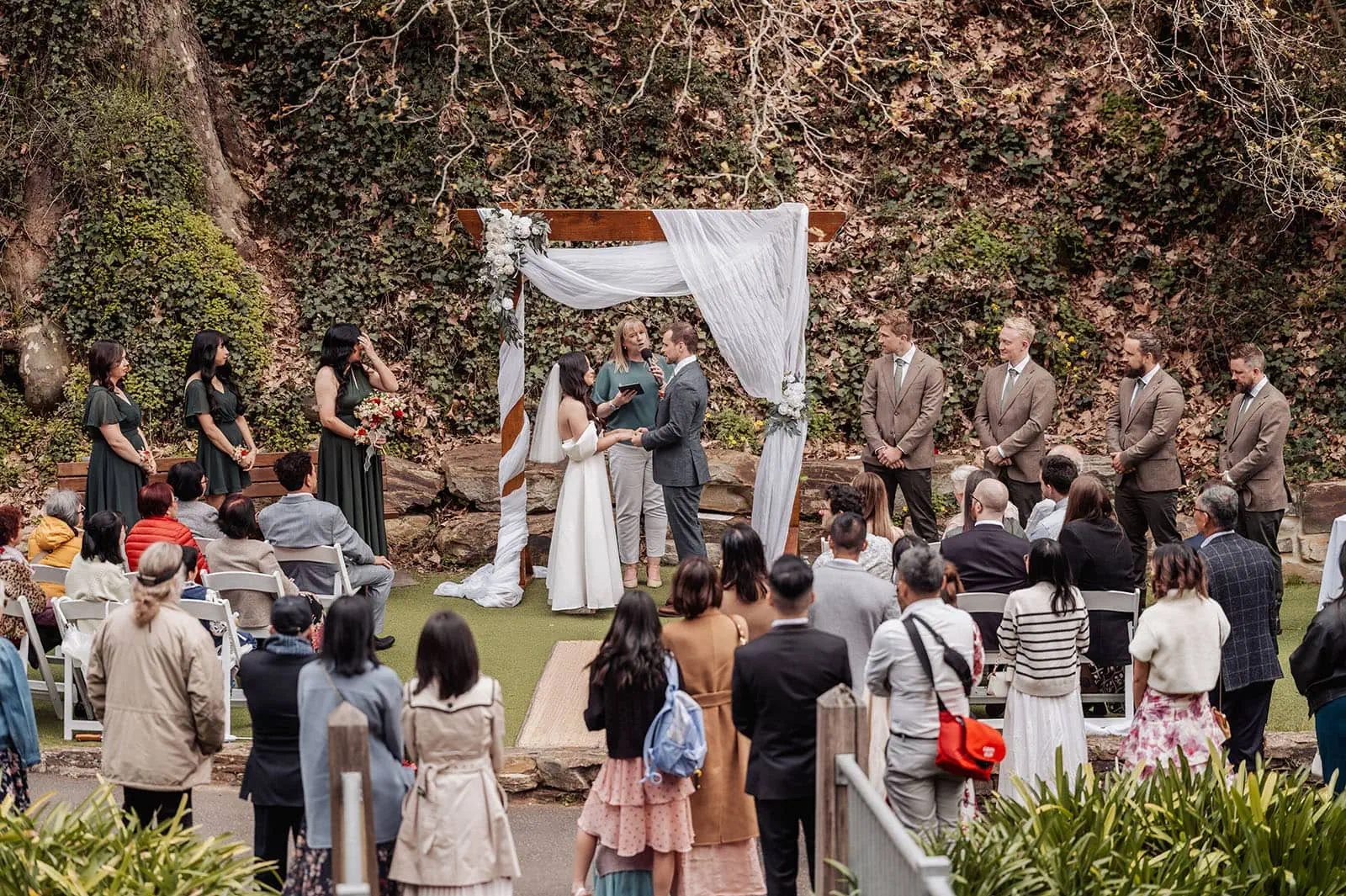 utopia waterfall gully wedding - sally & ben 224 Outdoor wedding ceremony with elegant decor and scenic natural backdrop.