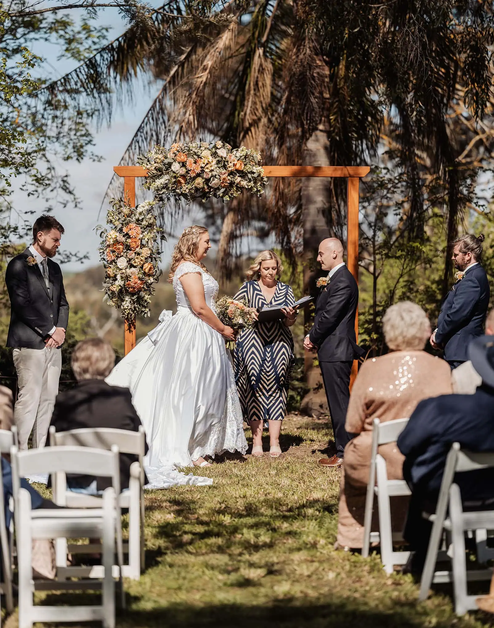 grand cru estate wedding - isabella & nick 123 Elegant outdoor wedding ceremony with scenic views and floral decorations.