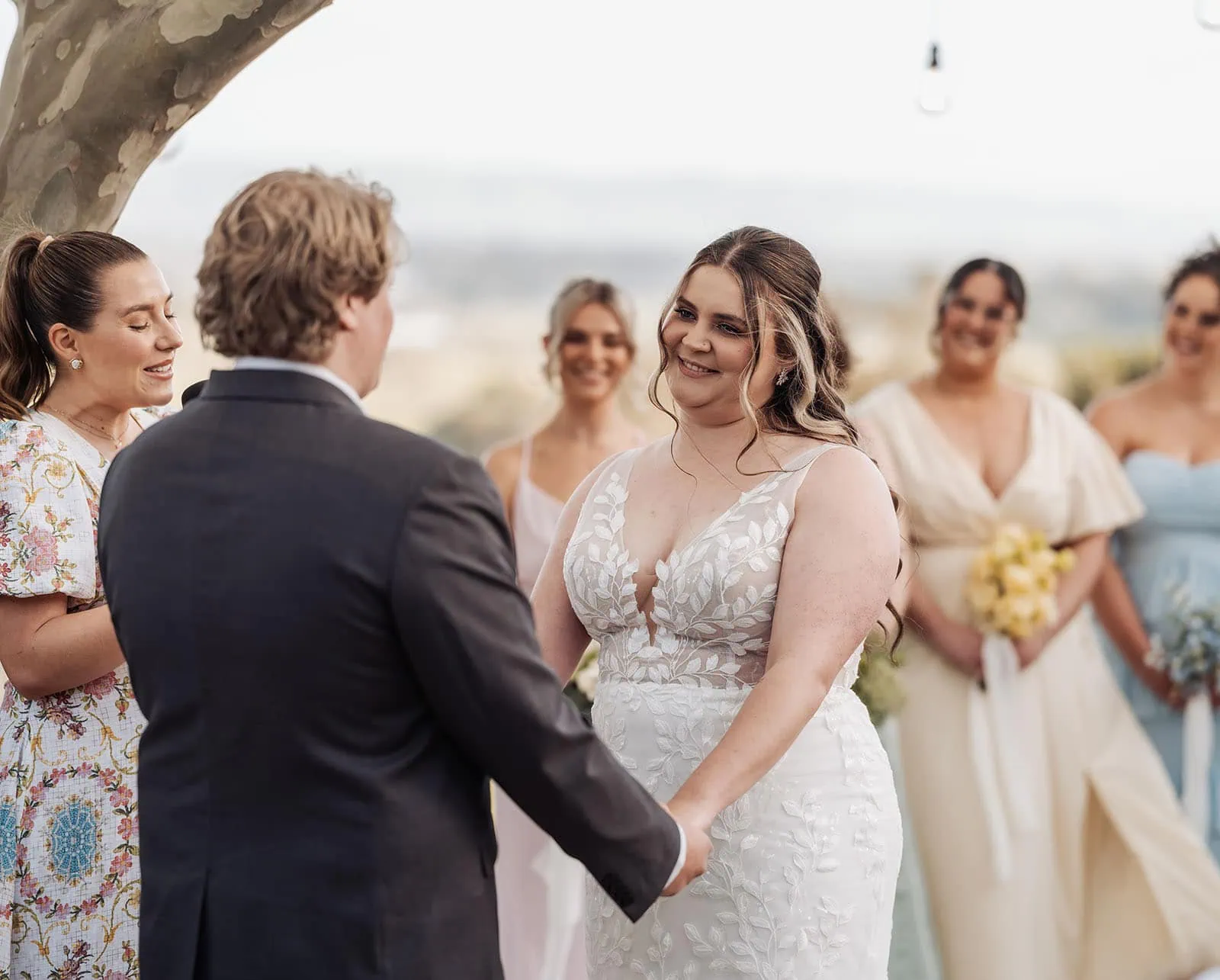 beach rd wines wedding - hana & jessie 62 Outdoor wedding ceremony with floral decorations and guests.