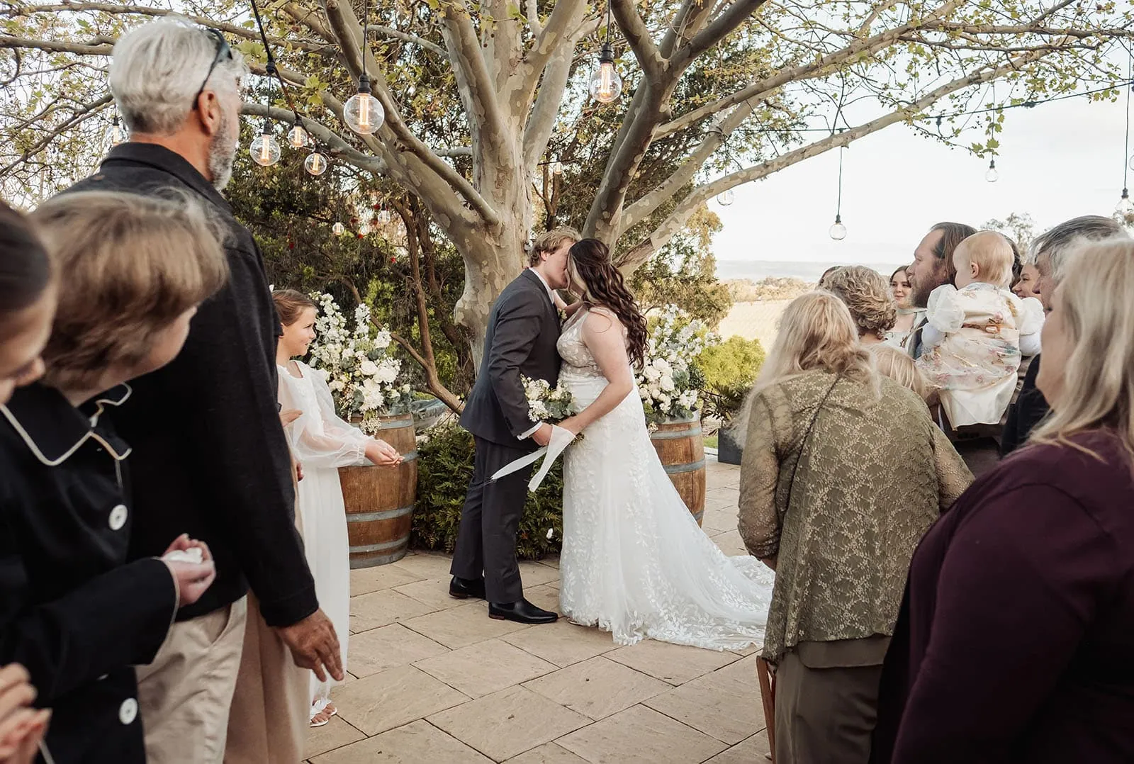 beach rd wines wedding - hana & jessie 66 Outdoor wedding ceremony in a garden setting with beautiful floral arrangements.