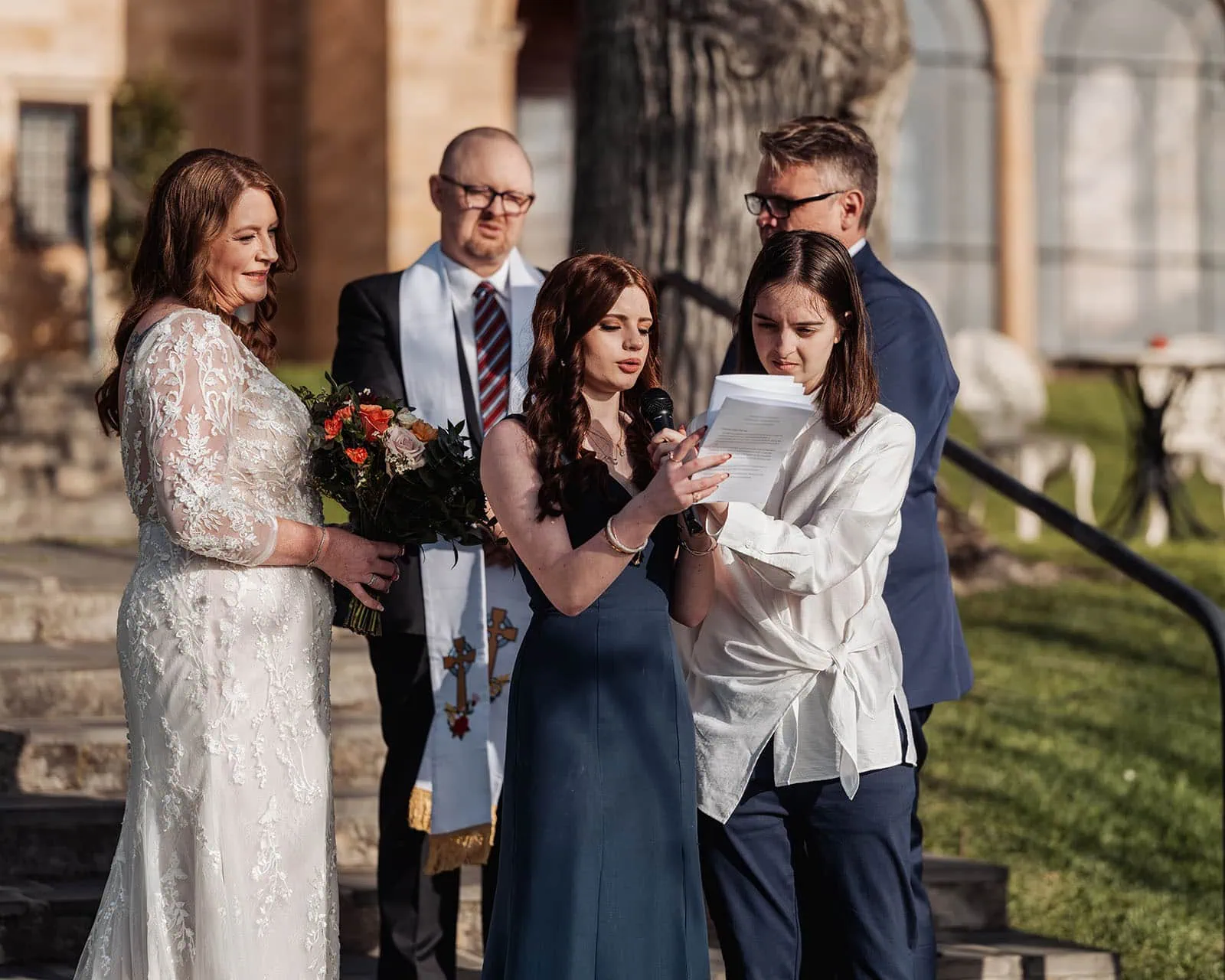 carrick hill wedding - jo & david 293 Outdoor wedding ceremony with elegant floral decor and bright sunny weather.