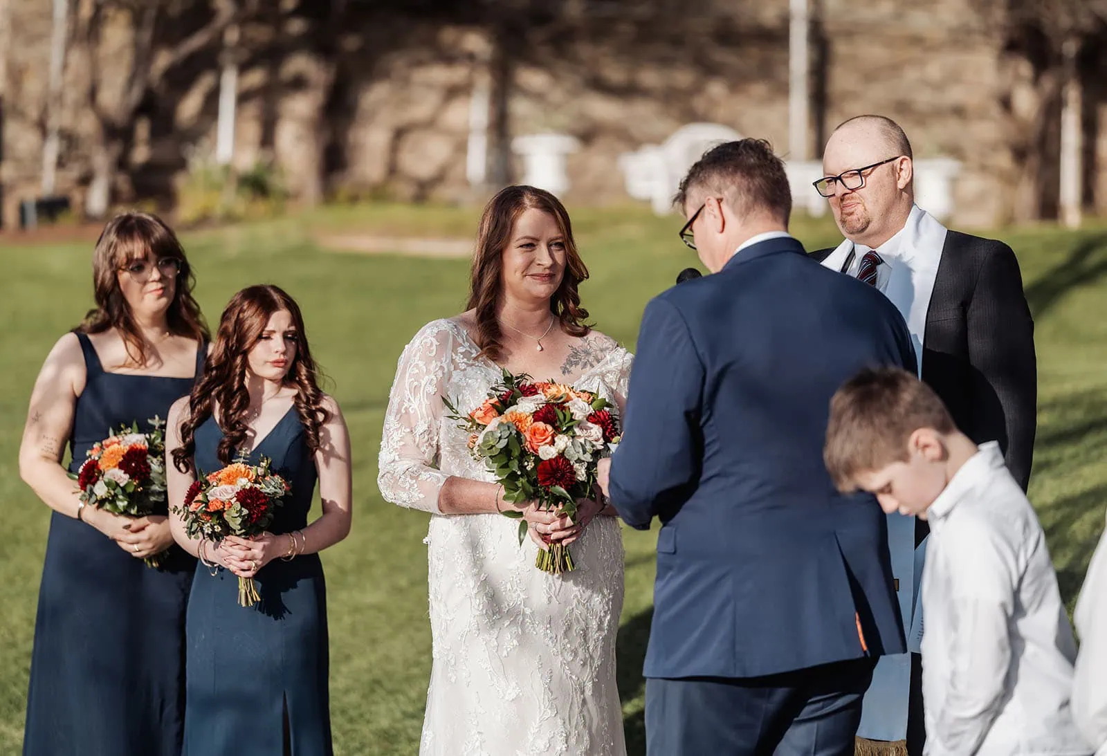 carrick hill wedding - jo & david 294 Scenic outdoor wedding ceremony in nature, elegant setup with flowers and chairs.