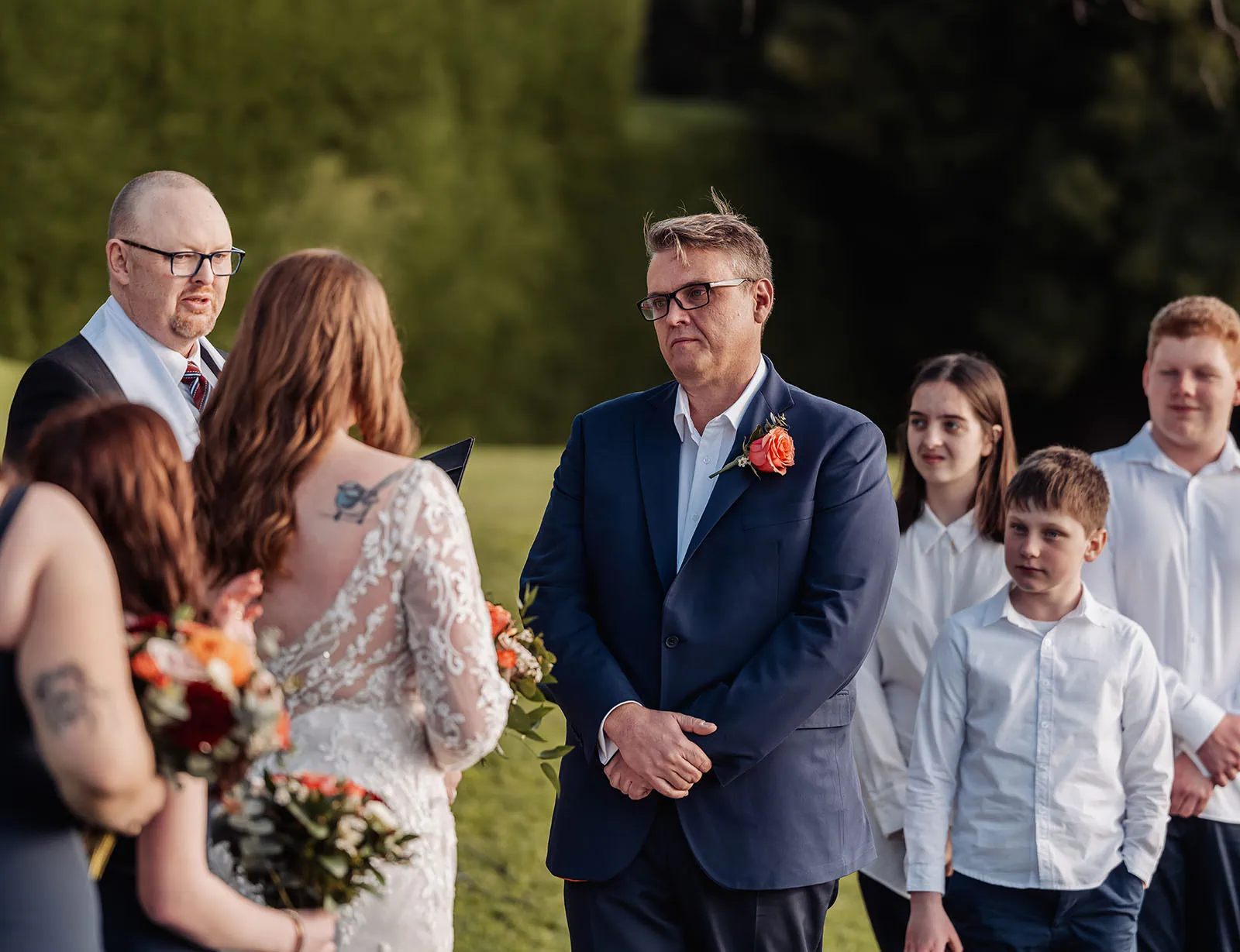 carrick hill wedding - jo & david 291 Garden wedding ceremony with floral decorations and guests seated outdoors.