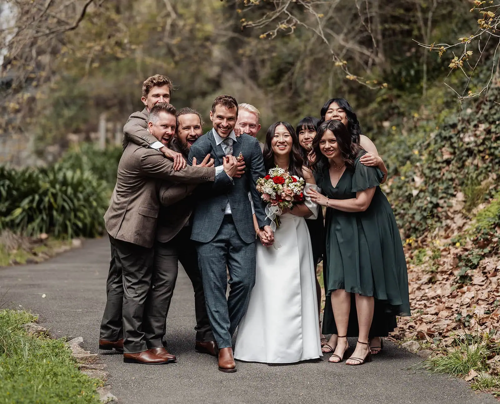 utopia waterfall gully wedding - sally & ben 234 Beautiful outdoor wedding scene with joyful bride and groom under sunny sky.