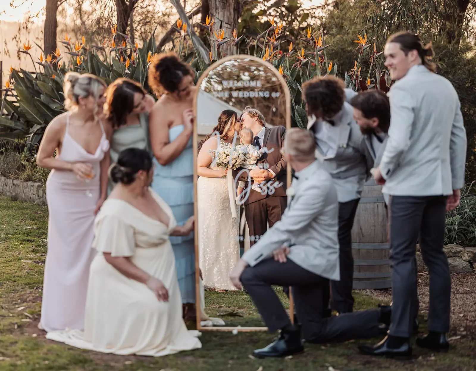 beach rd wines wedding - hana & jessie 71 Elegant outdoor wedding setup with decorative mirror reflecting flowers and greenery.