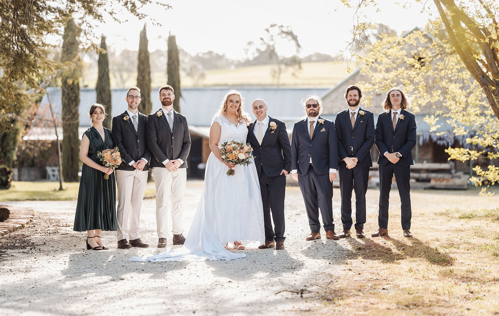 grand cru estate wedding - isabella & nick 136 Elegant outdoor wedding celebration with guests, floral decorations, and sunset ambiance.