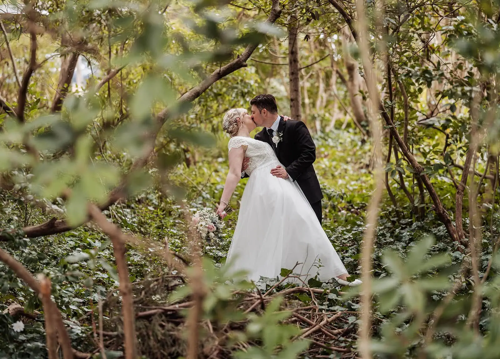 mt lofty house elopement - kimberley & michael 204 Enchanting forest wedding ceremony with romantic decorations and lush greenery.