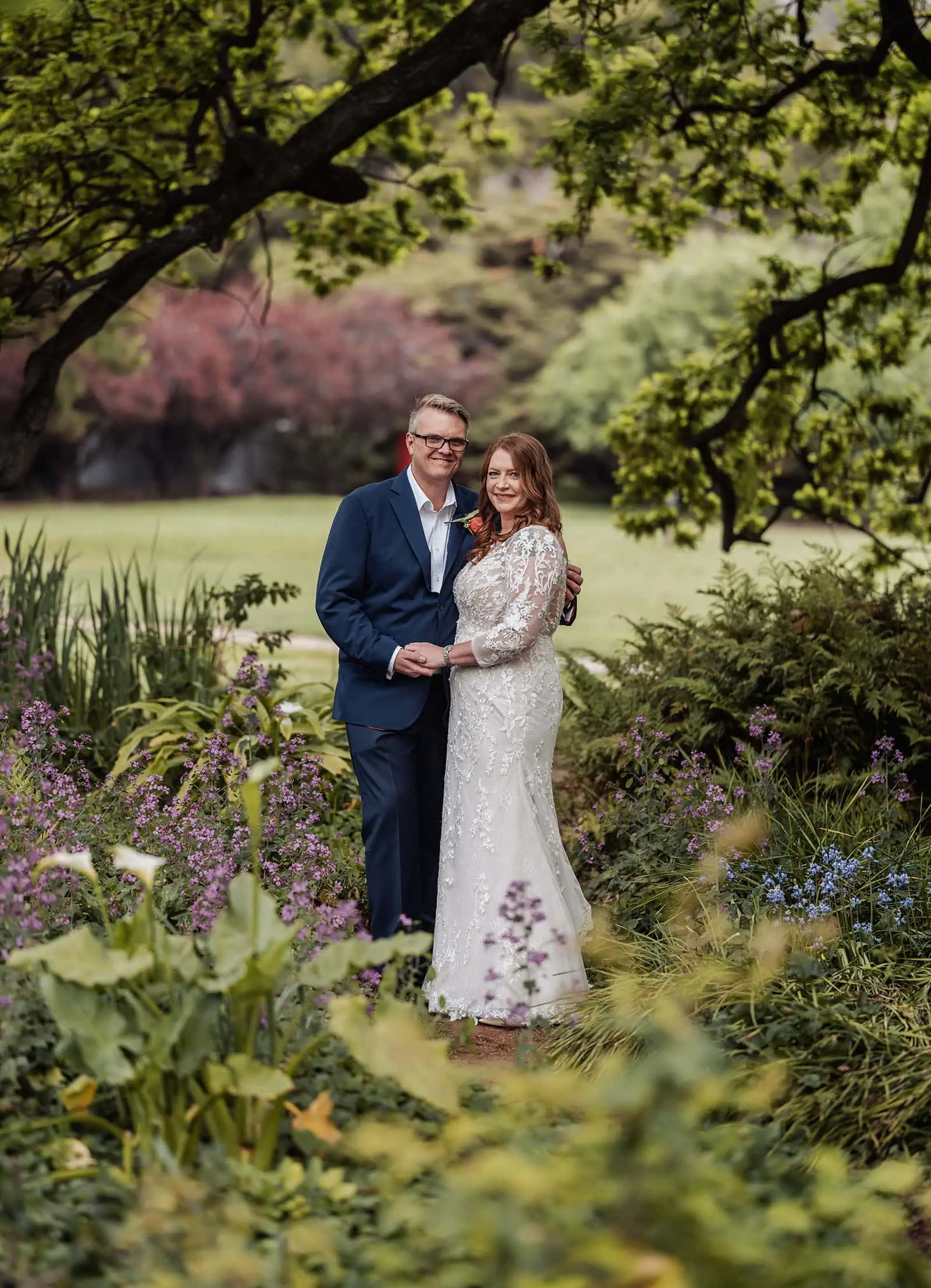carrick hill wedding - jo & david 284 Couple embracing in a lush, romantic garden setting.