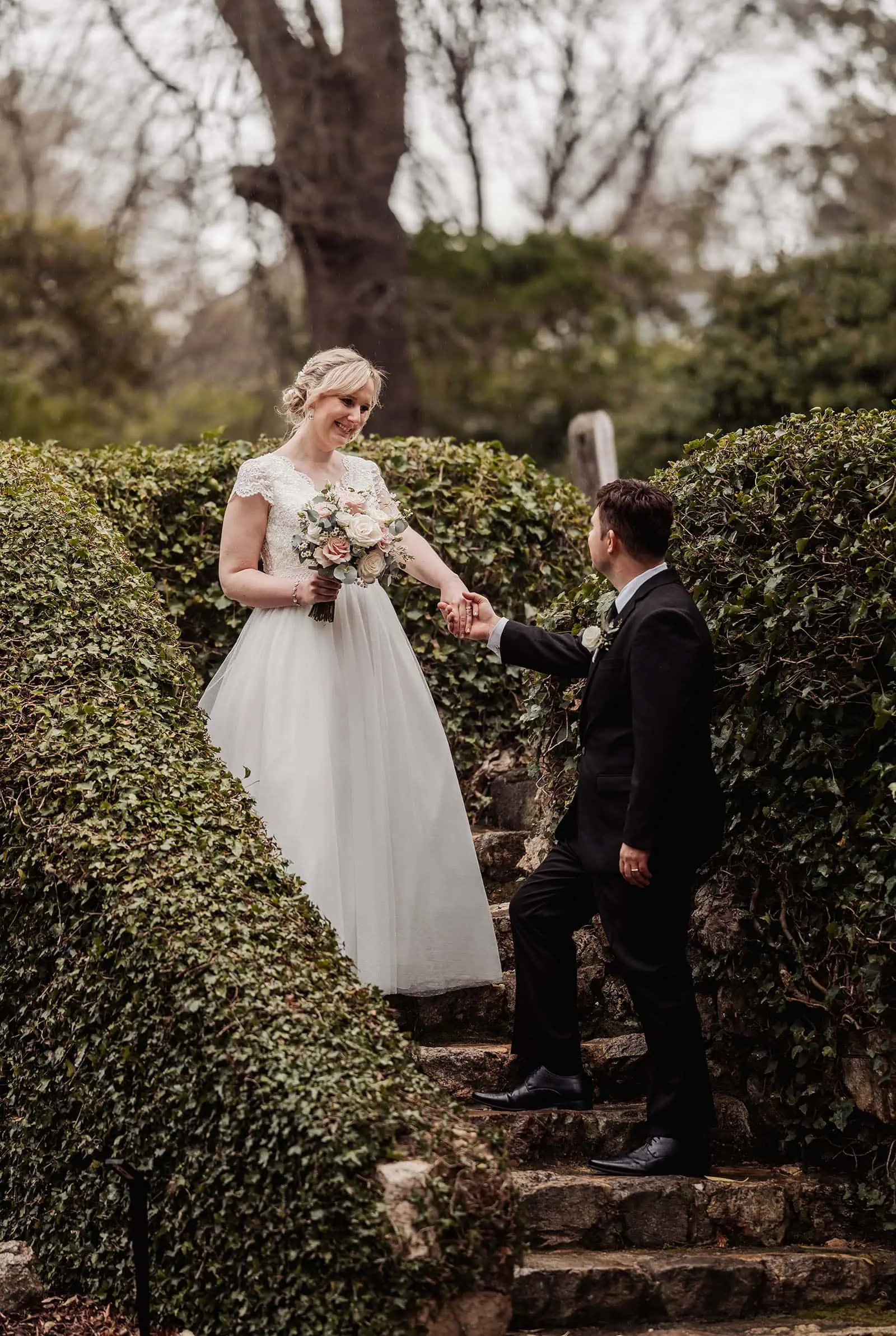 mt lofty house elopement - kimberley & michael 201 Couple embracing in a lush, romantic garden setting.