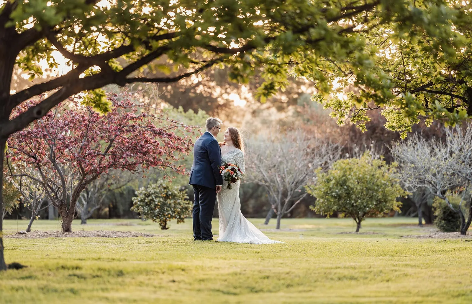 carrick hill wedding - jo & david 309 Elegant garden wedding scene with flowers and lights on a romantic evening.