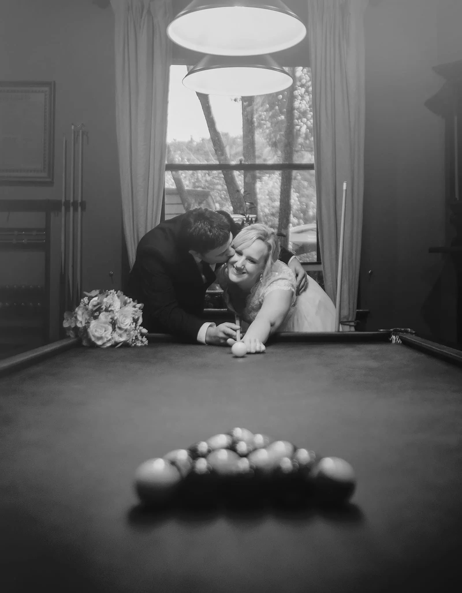 mt lofty house elopement - kimberley & michael 200 Couple enjoying a romantic moment at a pool table.