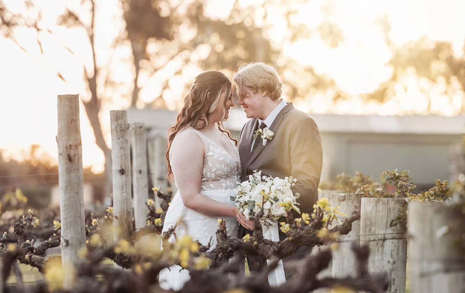 beach rd wines wedding - hana & jessie 78 Couple enjoying a romantic moment in a scenic vineyard.
