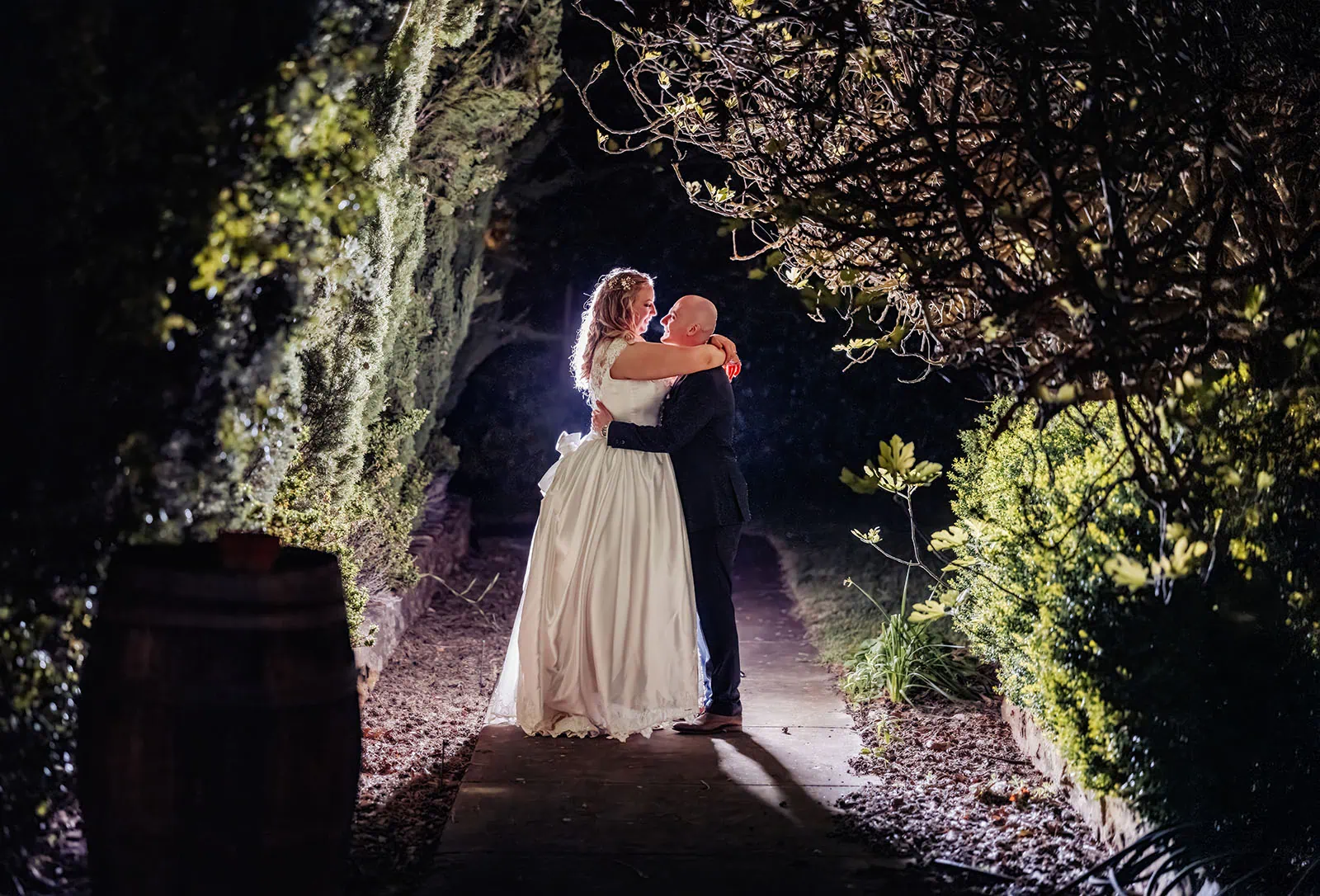 grand cru estate wedding - isabella & nick 167 Bride and groom share a romantic kiss, captured at an elegant outdoor wedding ceremony.