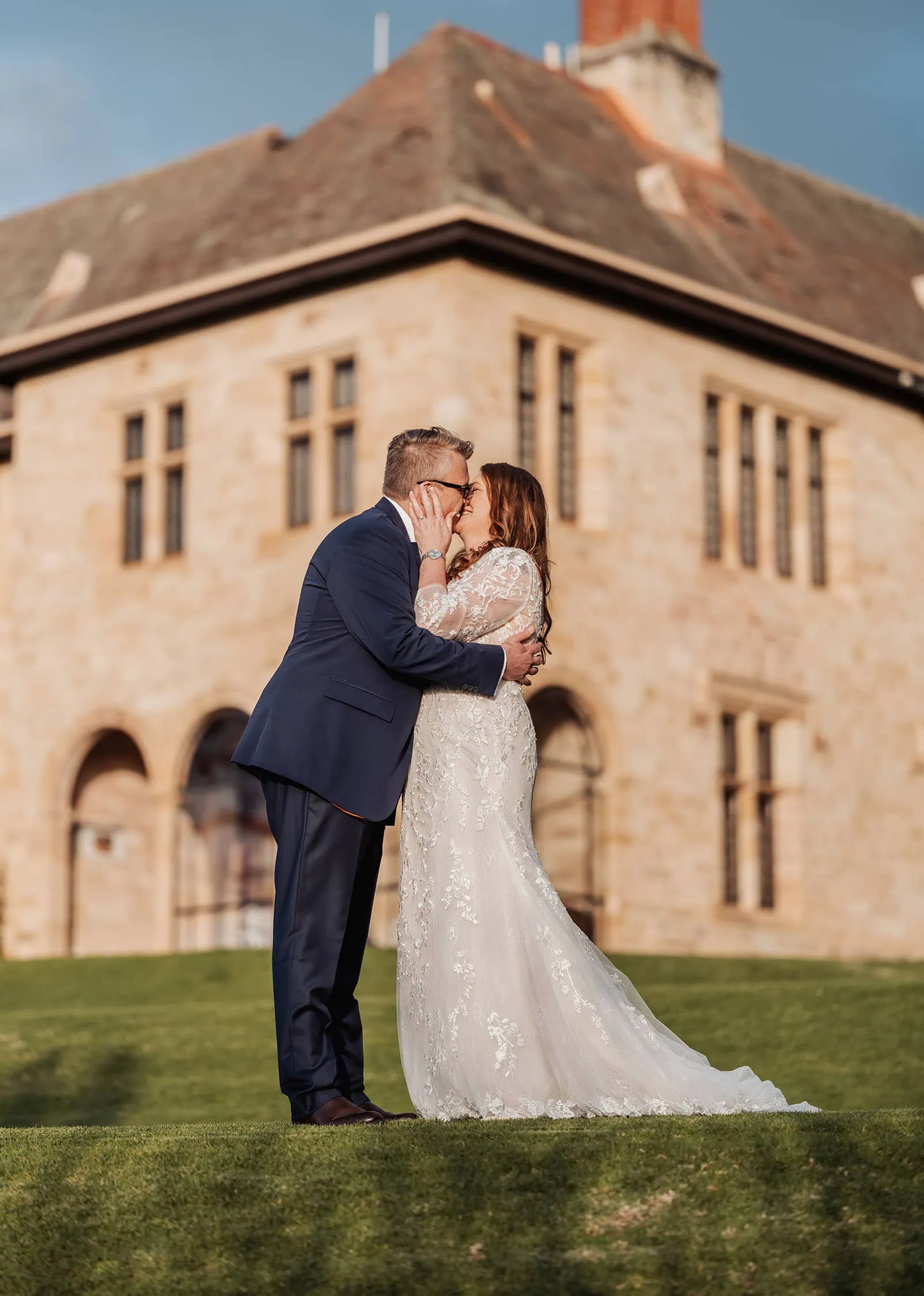 carrick hill wedding - jo & david 299 Bride and groom sharing a romantic kiss during their wedding ceremony.