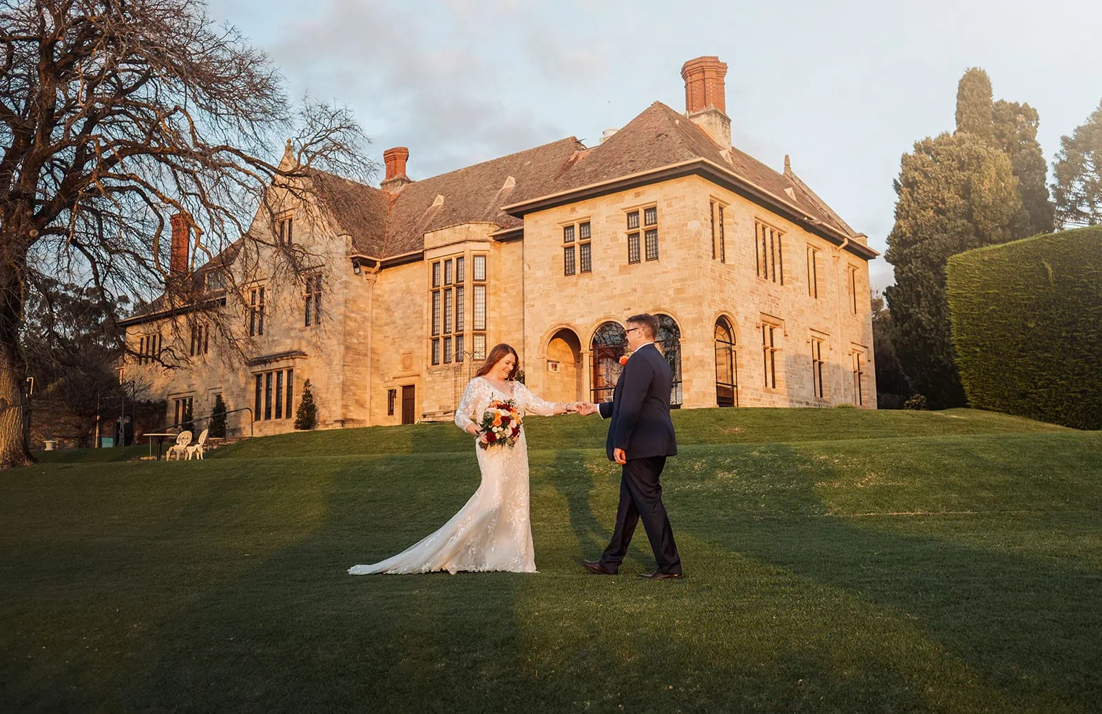 carrick hill wedding - jo & david 316 Elegant wedding couple embraces in a picturesque garden setting.
