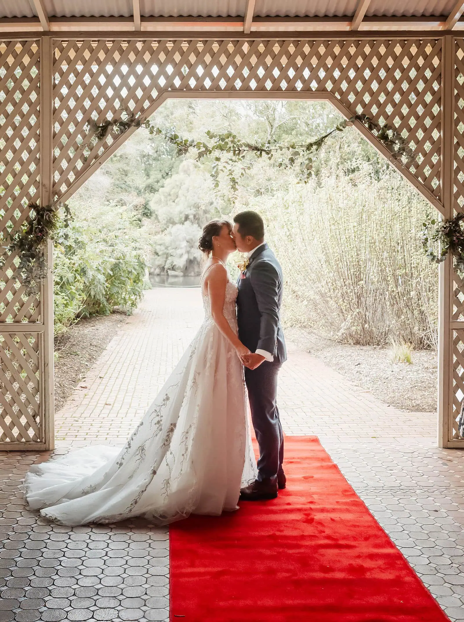 adelaide botanic gardens summerhouse wedding - belinda & ian 169 Elegant outdoor wedding ceremony with floral decor and happy couple.