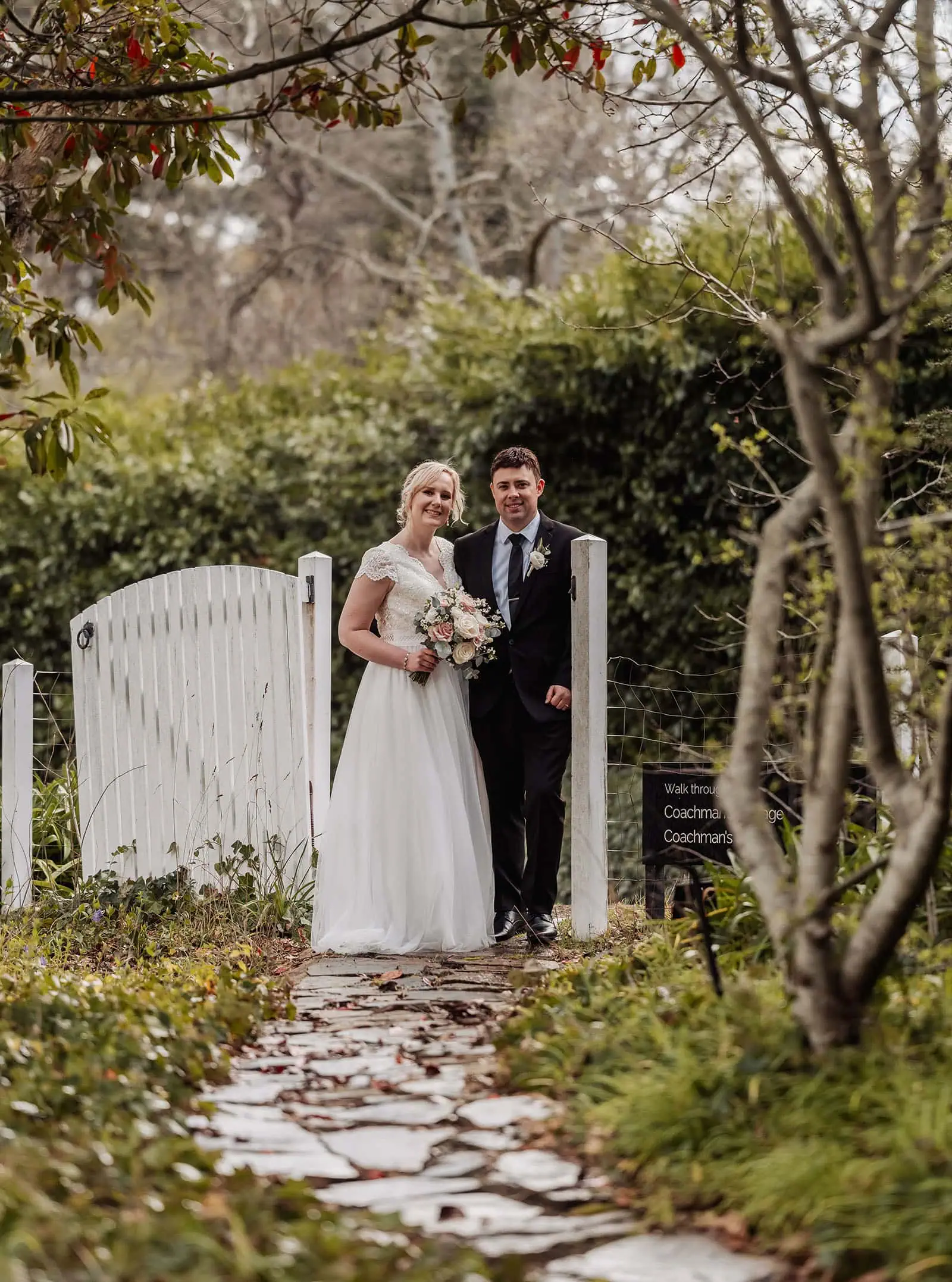 mt lofty house elopement - kimberley & michael 212 Rustic wedding gate adorned with flowers, vintage decor, countryside setting.