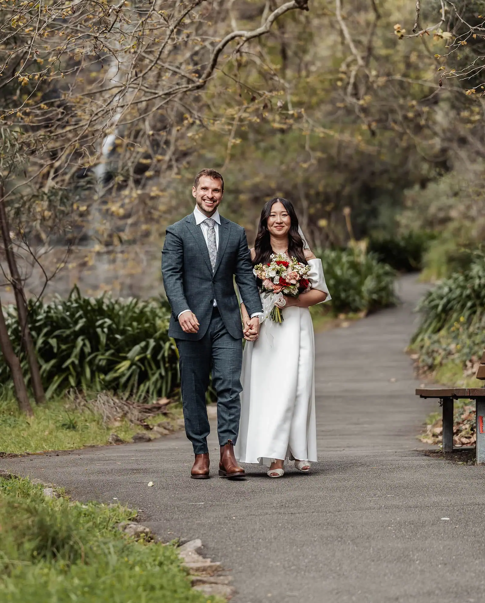 utopia waterfall gully wedding - sally & ben 232 Peaceful couple walking on forest path enjoying nature.
