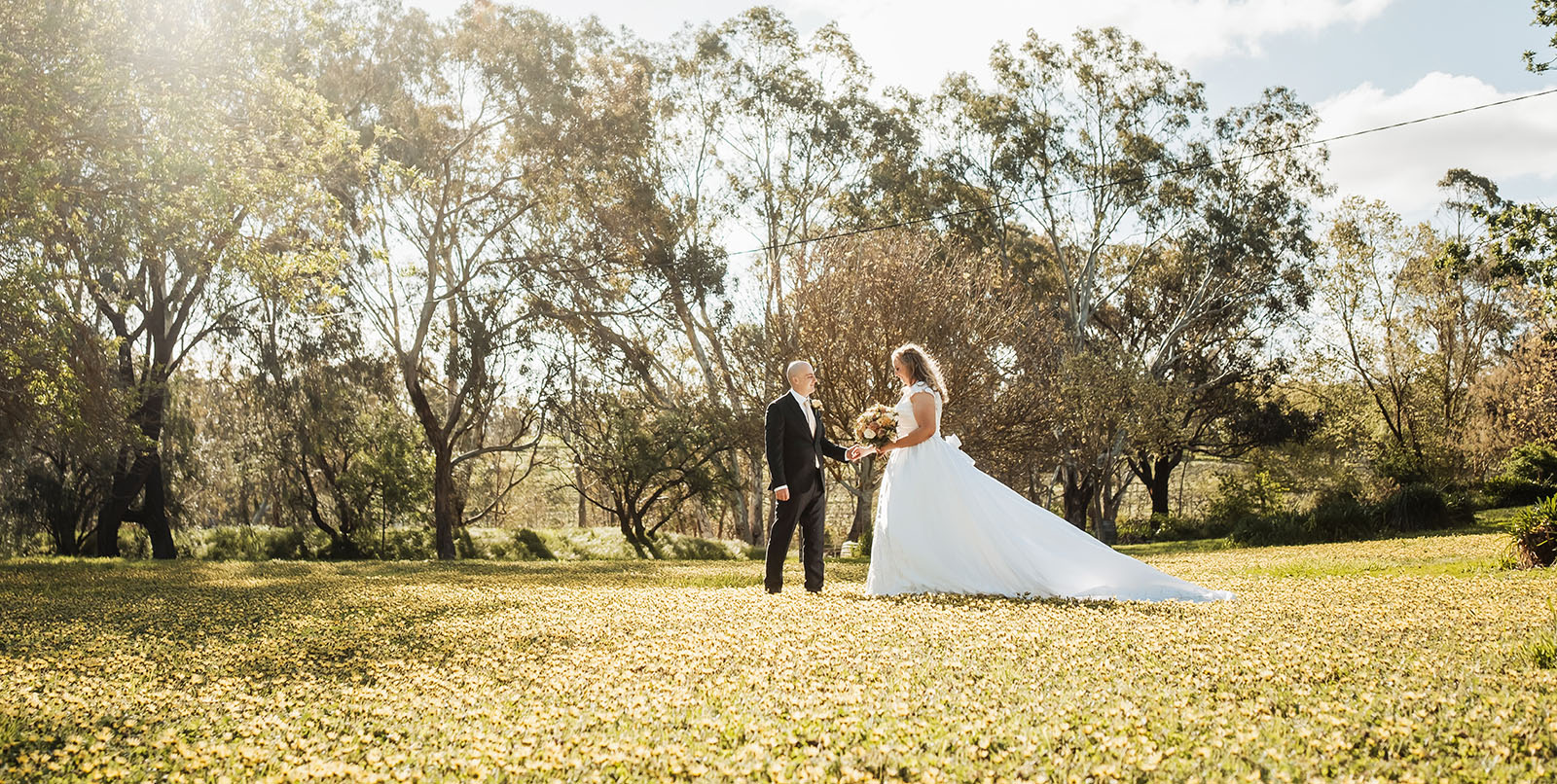 grand cru estate wedding - isabella & nick 140 Outdoor wedding ceremony with elegant decorations under a clear sky.