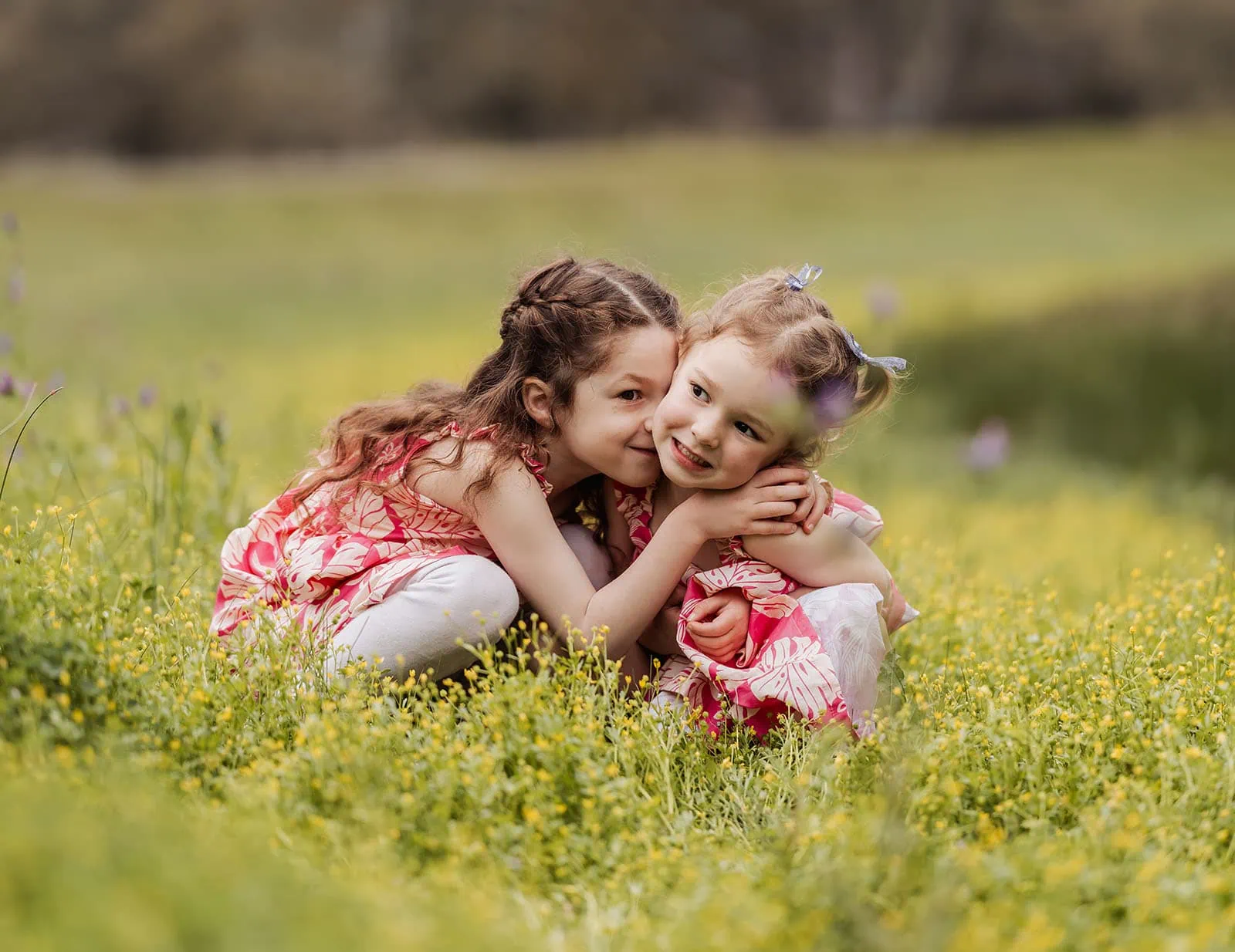 happy valley reservoir family photoshoot 18 Siblings playing joyfully in a sunny field, showcasing a strong bond and family love.
