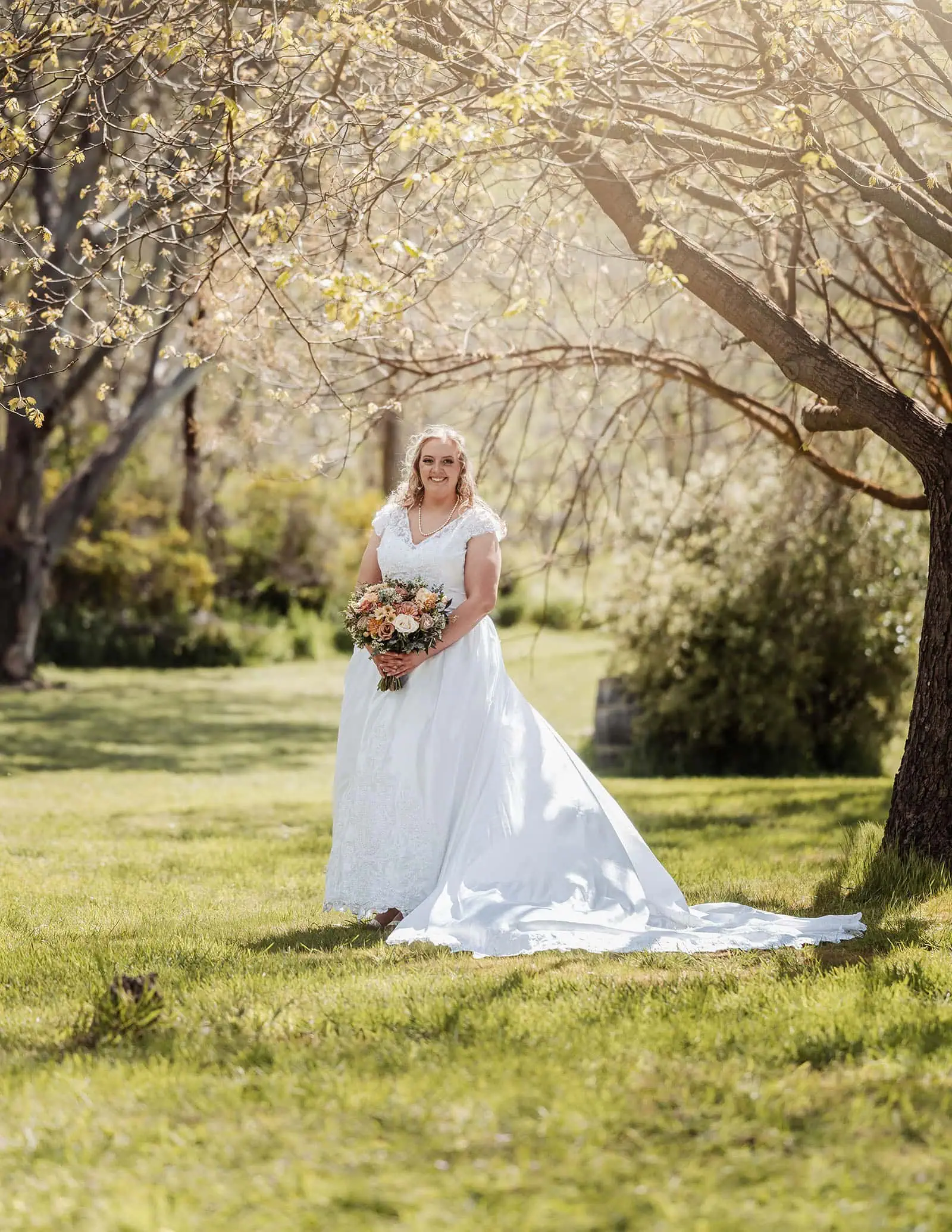 grand cru estate wedding - isabella & nick 117 Bride in blooming spring garden wearing elegant dress.