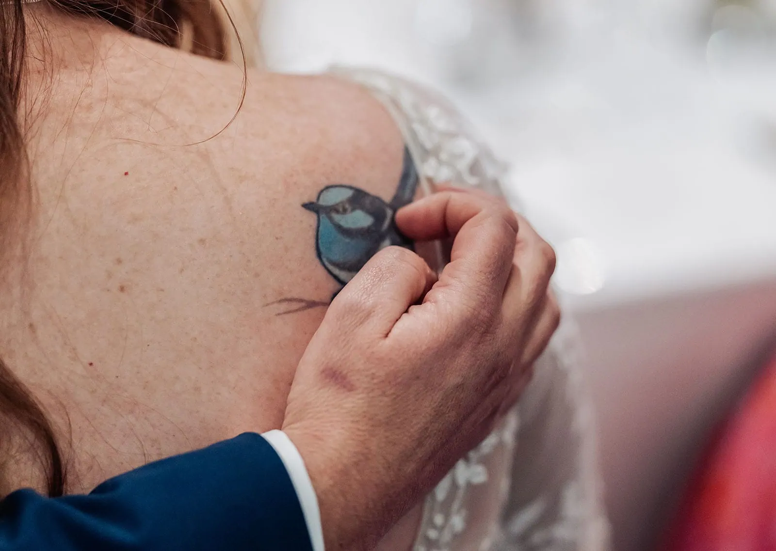 carrick hill wedding - jo & david 321 Person touching shoulder tattoo with intricate design.
