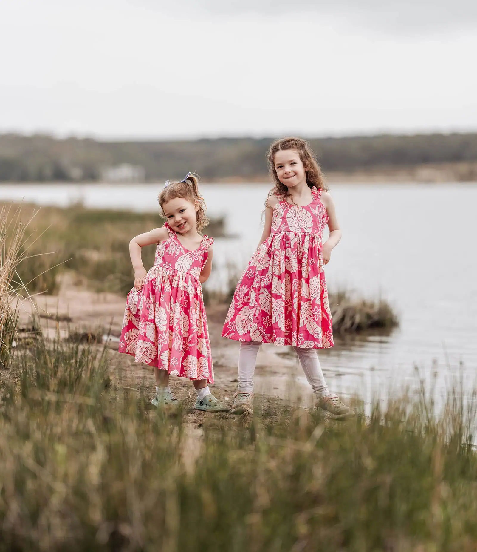 happy valley reservoir family photoshoot 12 Two girls enjoying a scenic waterfront view, capturing joyful moments together.