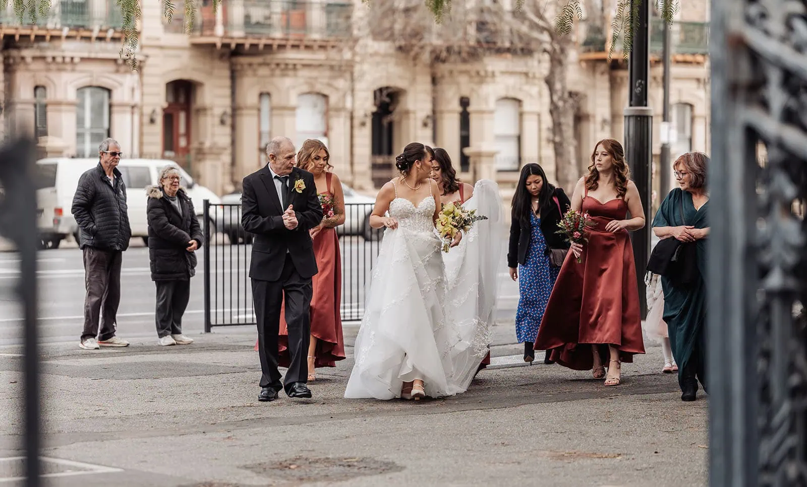 adelaide botanic gardens summerhouse wedding - belinda & ian 160 Urban wedding procession with joyful guests and elegant decorations.
