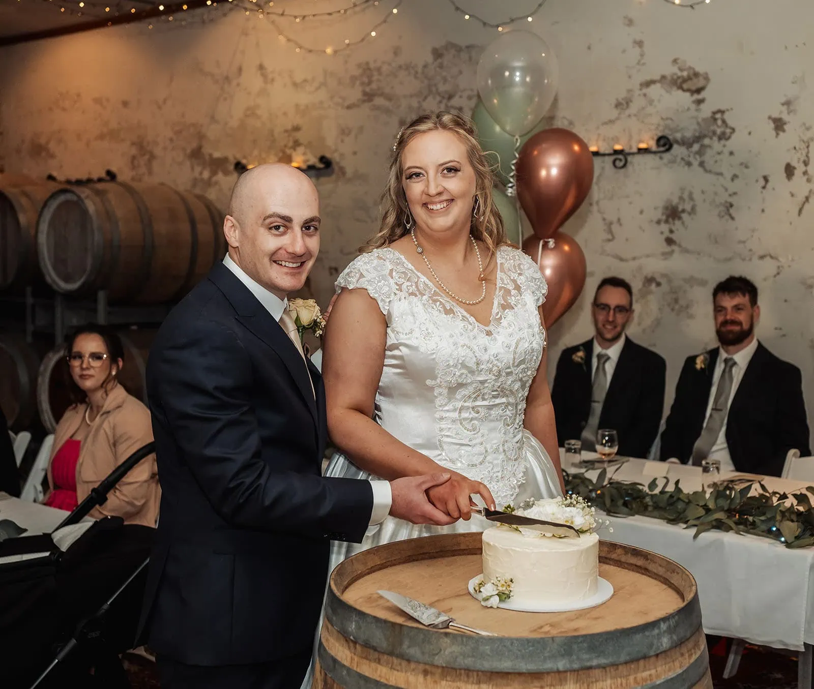 grand cru estate wedding - isabella & nick 156 Bride and groom joyfully cutting elegant white wedding cake.