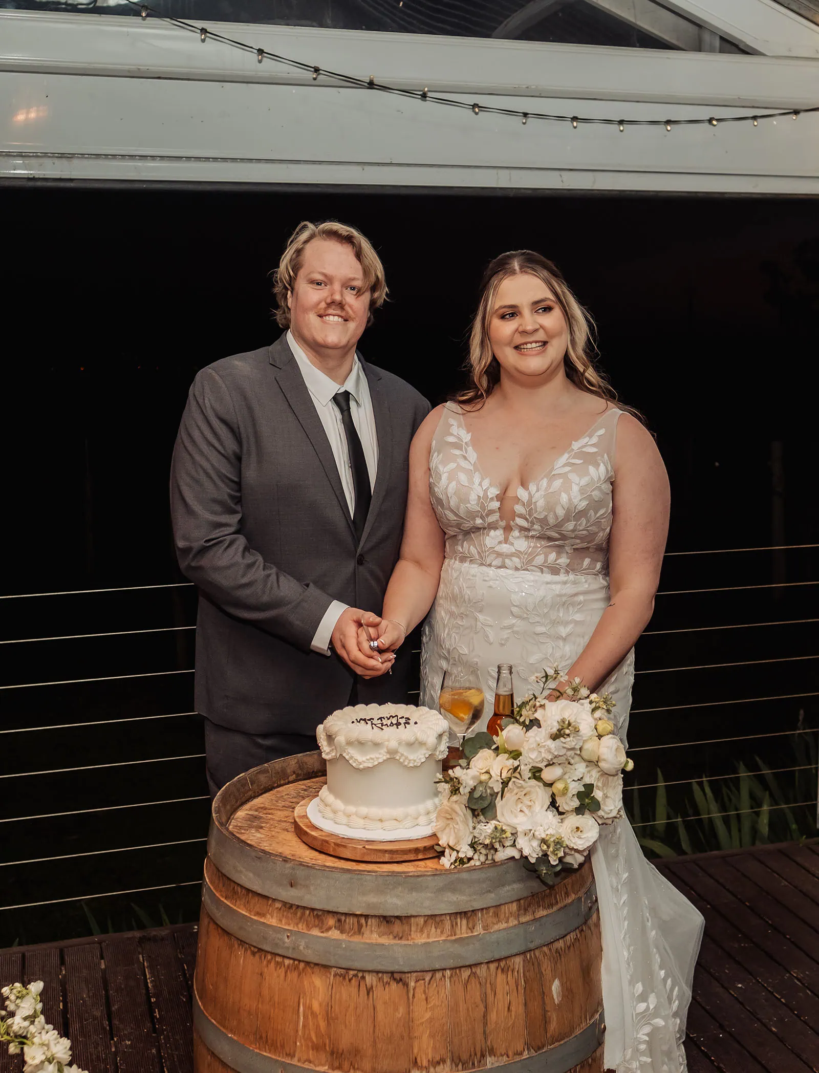 beach rd wines wedding - hana & jessie 90 Bride and groom cutting elegant wedding cake during reception ceremony.