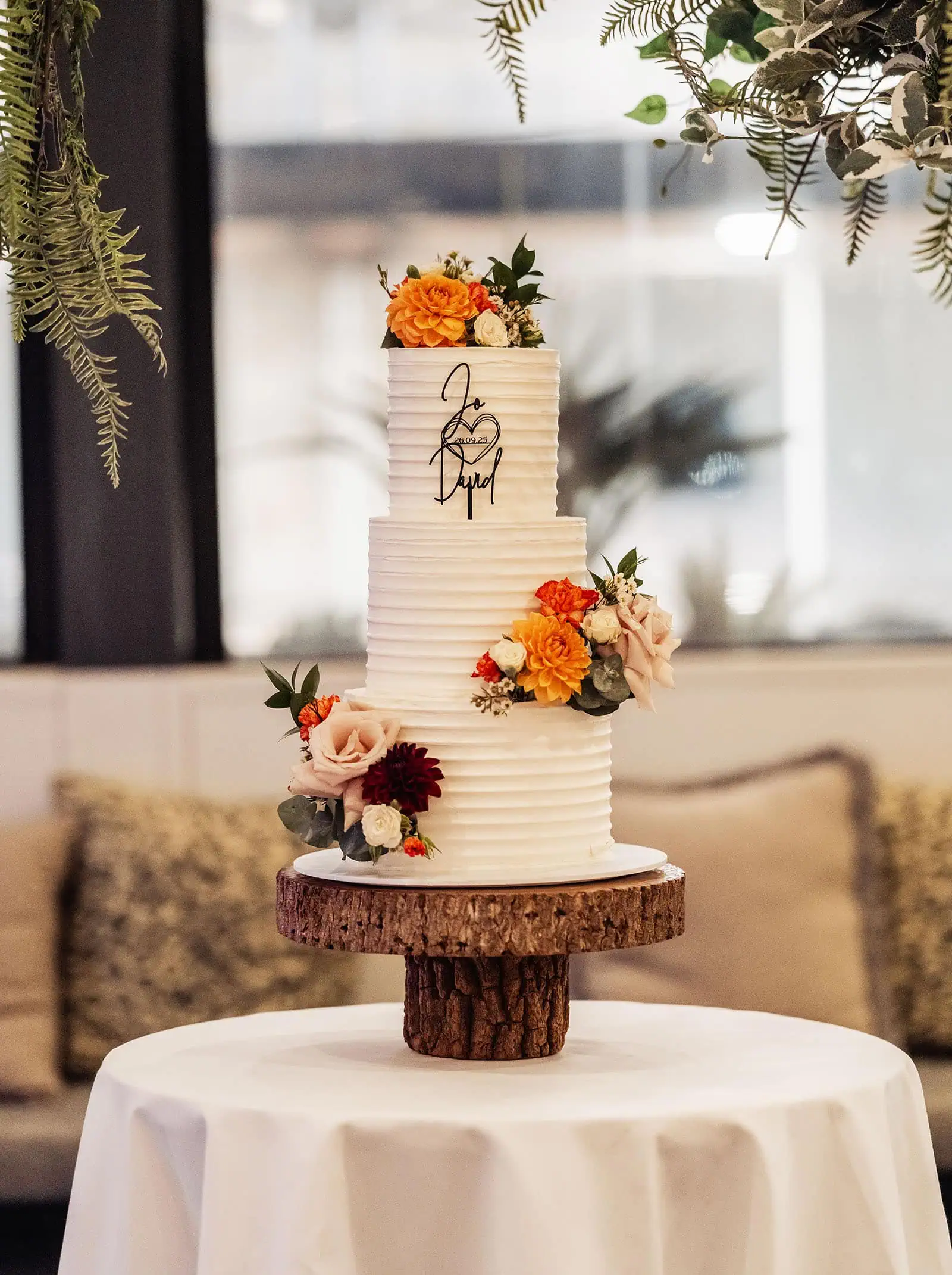 carrick hill wedding - jo & david 319 Elegant tiered wedding cake adorned with fresh flowers.